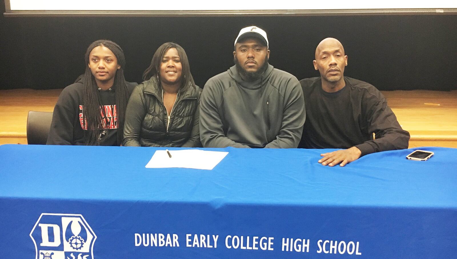 Dunbar High School senior Jonathan Allen (middle) is joined by twin sister Mone’t allen, mom Monique Harris and father Johnny Allen (right) at the school after signing to play football at the University of Cincinnati on Wednesday, Feb. 6, 2019. MARC PENDLETON / STAFF