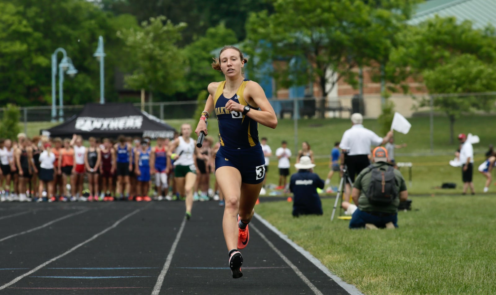 Oakwood's Grace Hartman crosses the finish line on the final leg of the 3,200-meter relay at the Division II state track and field championships on Friday, June 4, 2021, at Pickerington North High School. Oakwood won the state championship in the event. David Jablonski/Staff