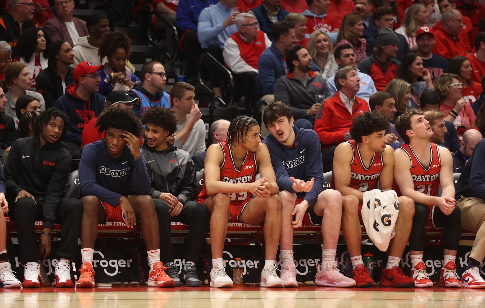 Dayton players on the bench, including Javon Bennett, third from left, watch a game against Virginia Commonwealth on Friday, March 8, 2024, at UD Arena. David Jablonski/Staff