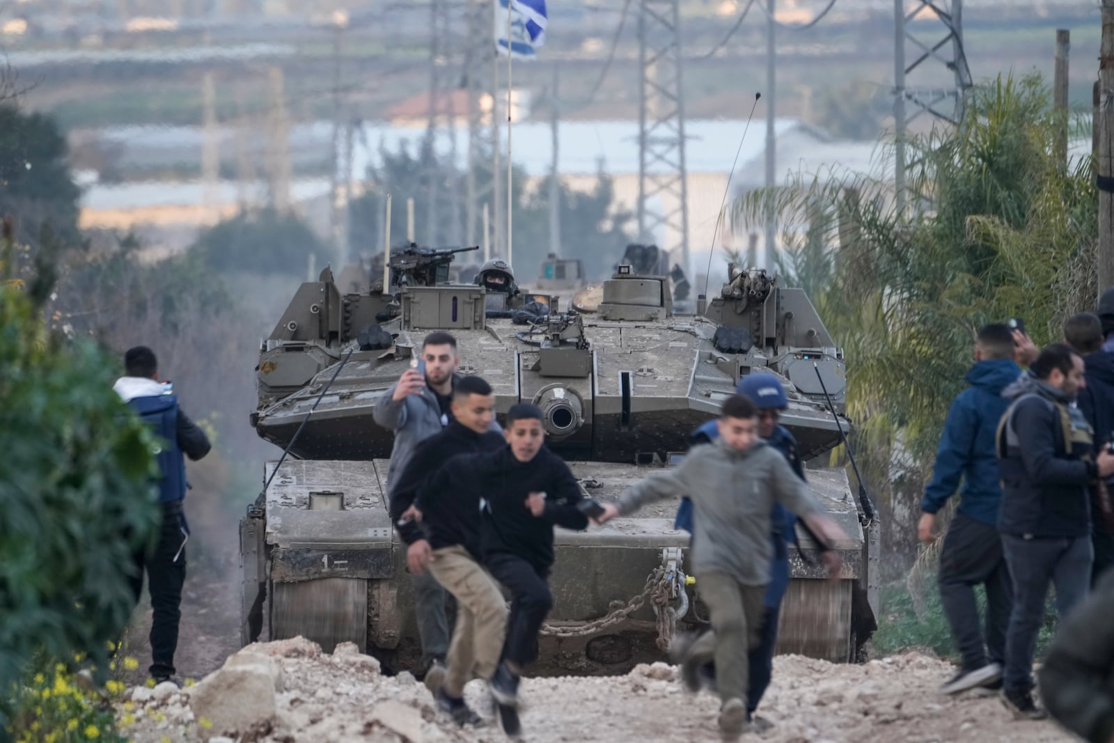 Israeli tanks drive towards the occupied West Bank of Jenin camp, Sunday, Feb. 23, 2025. (AP Photo/Majdi Mohammed)