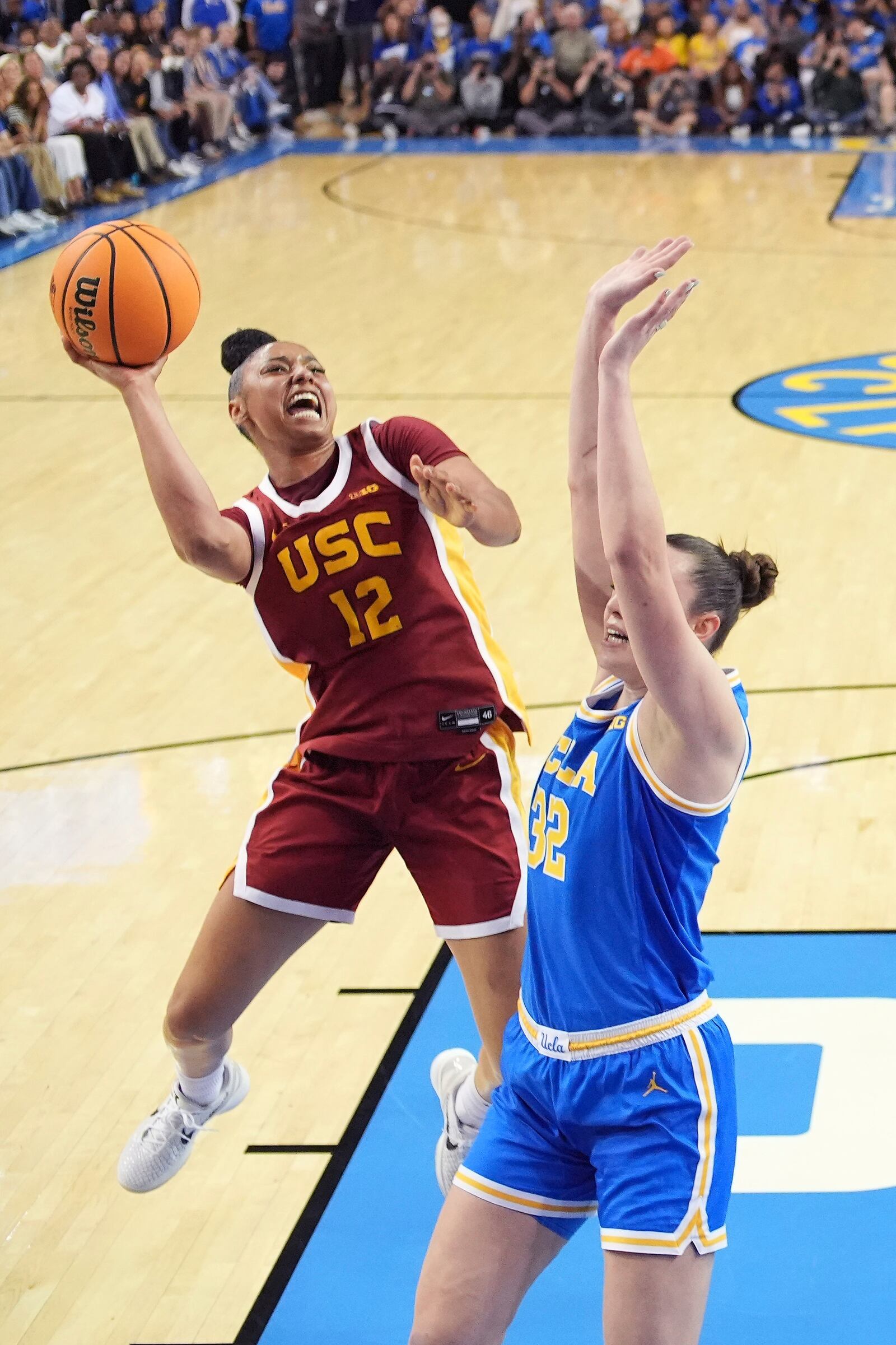 Southern California guard JuJu Watkins, left, shoots as UCLA forward Angela Dugalic defends during the first half of an NCAA college basketball game Saturday, March 1, 2025, in Los Angeles. (AP Photo/Mark J. Terrill)