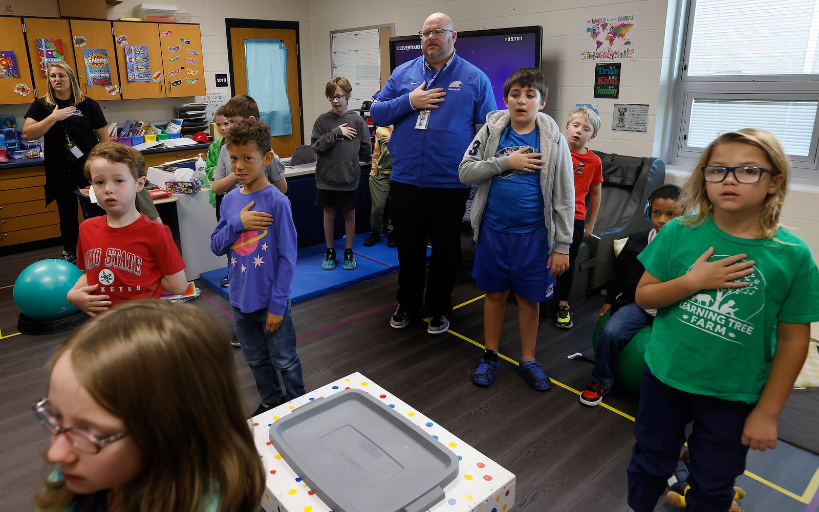 Zack Lewis, Behavior Intervention Specialist at Dennis Elementary leads a daily "Lew Crew" in the pledge of allegiance Wednesday, Oct. 23, 2024. MARSHALL GORBY\STAFF