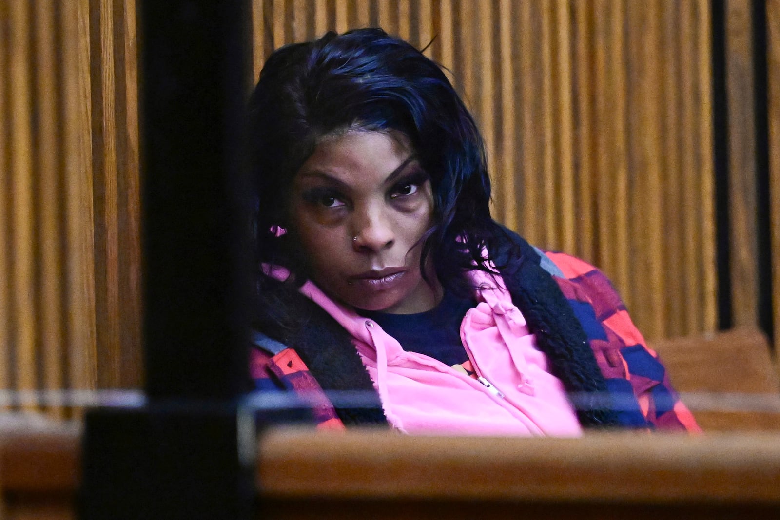 Fiona Allen fills out paperwork after being arraigned in Cuyahoga County Common Pleas Court, Tuesday, Dec. 3, 2024. Allen is accused of illegally voting in five different elections since 2020. Though Allen is a legal resident of the United States, prosecutors say she is not an American citizen. (AP Photo/David Dermer)