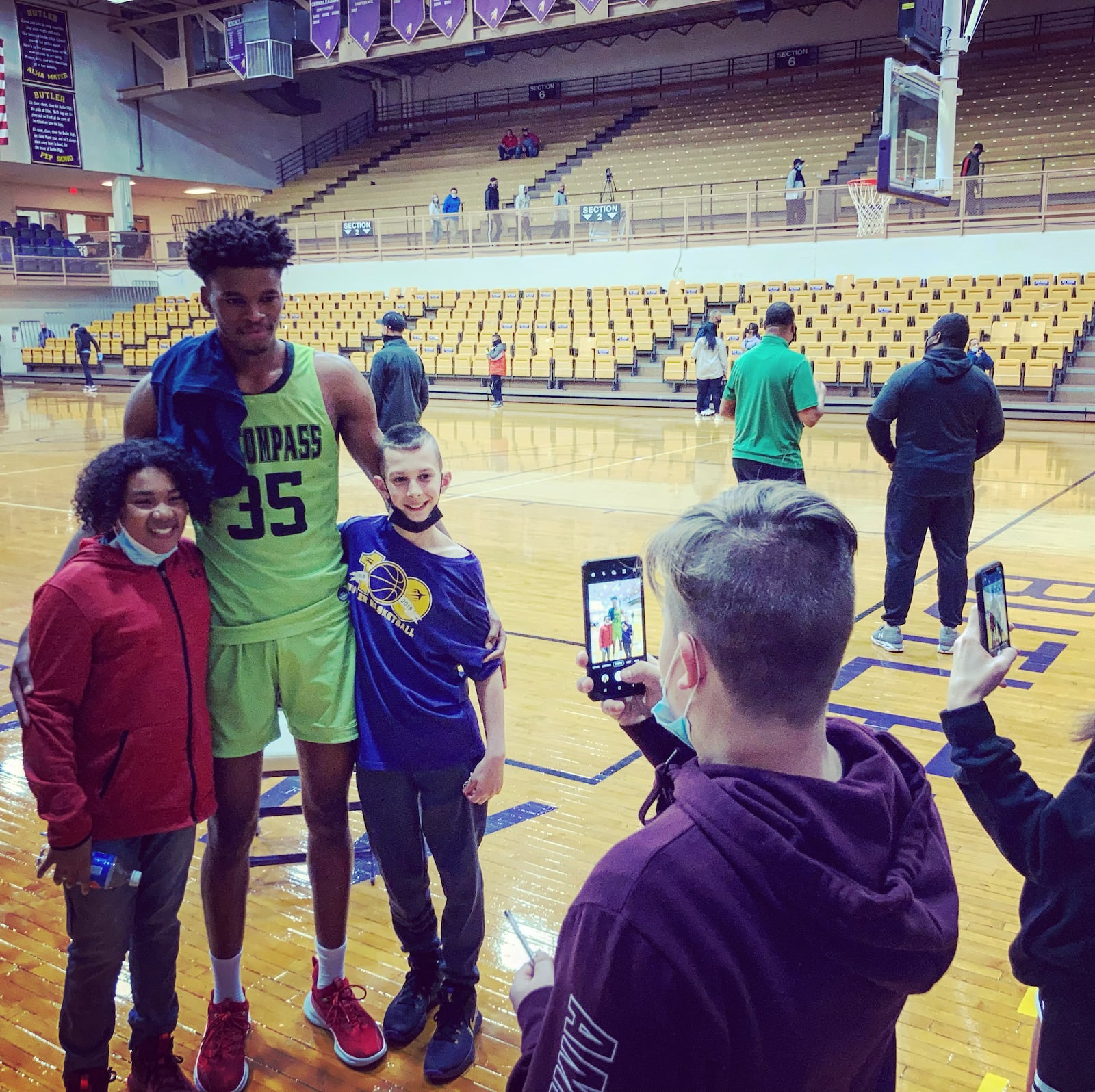 Dayton recruit DaRon Holmes, a senior at AZ Compass Prep, poses for a photo with fans at the Top Gun Showcase after a game against Ypsi Prep at Butler High School in Vandalia on Monday, March 8, 2021. David Jablonski/Staff