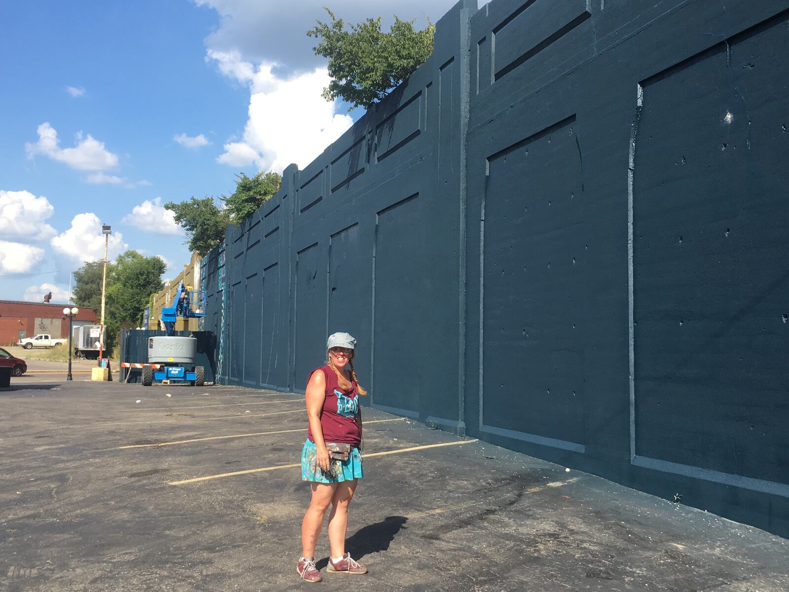 Brian Ferguson, the owner of Zada Paint Works, painted the base coat of the wall at the entrance of the Oregon District. A mural is now being painted on the wall.  This photo was taken after Ferguson applied paint.