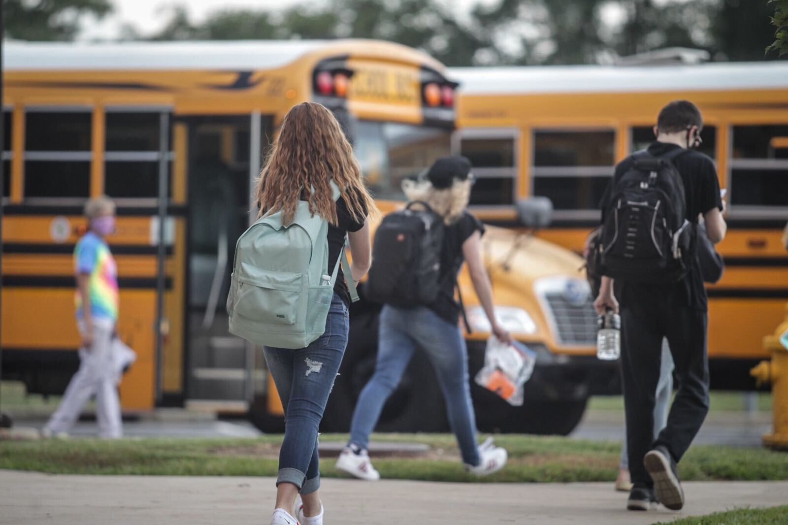 Mad River Middle School students load onto the buses after the first day of school Sept. 8, 2020. Jim Noelker/Staff