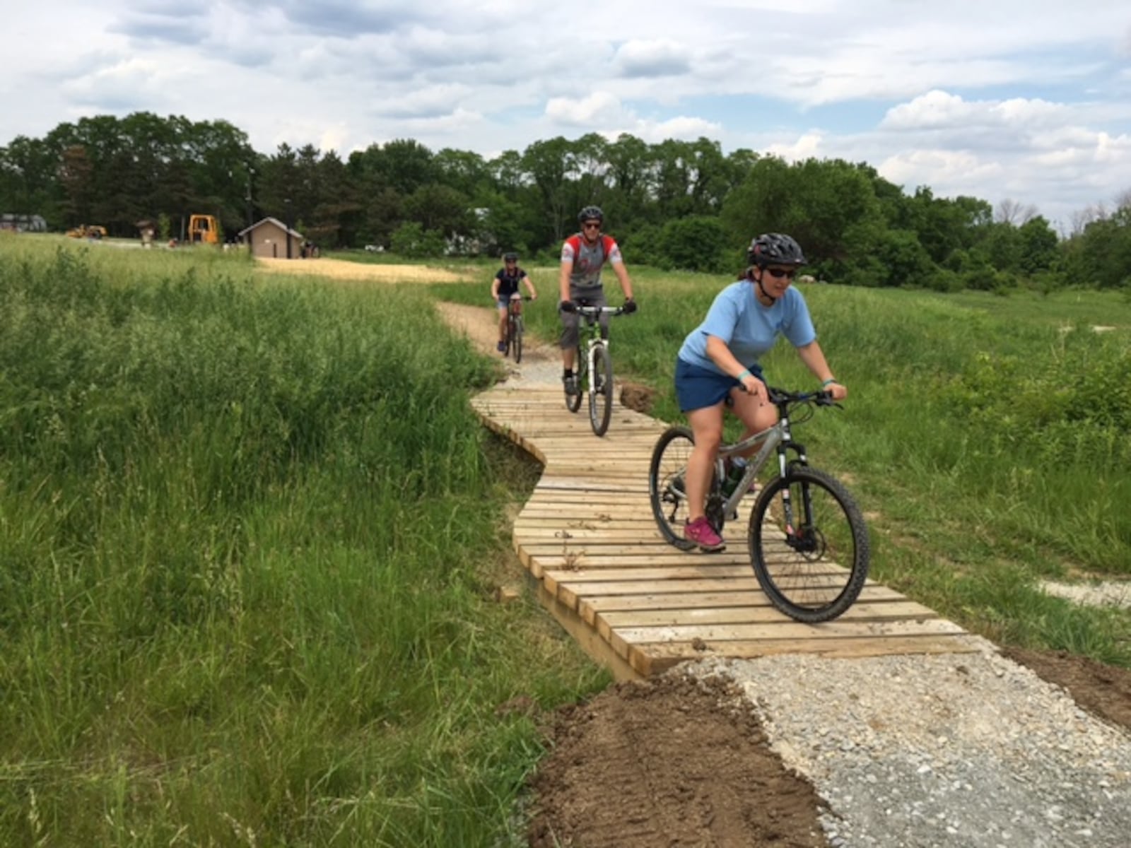 Three MetroParks employees try out the new Hilltop Flow trail at Huffman MetroPark’s mountain biking facility.