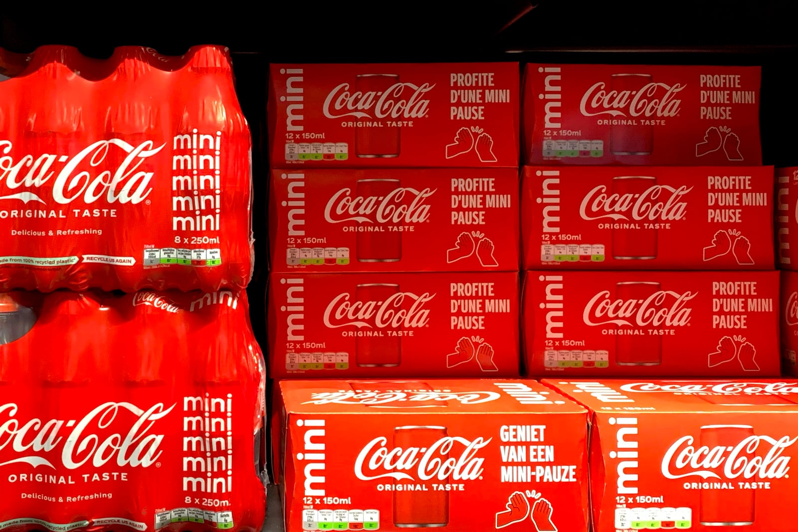 Cleared cases of soft drinks sit on a shelf in a supermarket in Antwerp, Belgium, after Coca-Cola recalled some of its soft drinks in Europe, Tuesday, Jan. 28, 2025. (AP Photo/Virginia Mayo)