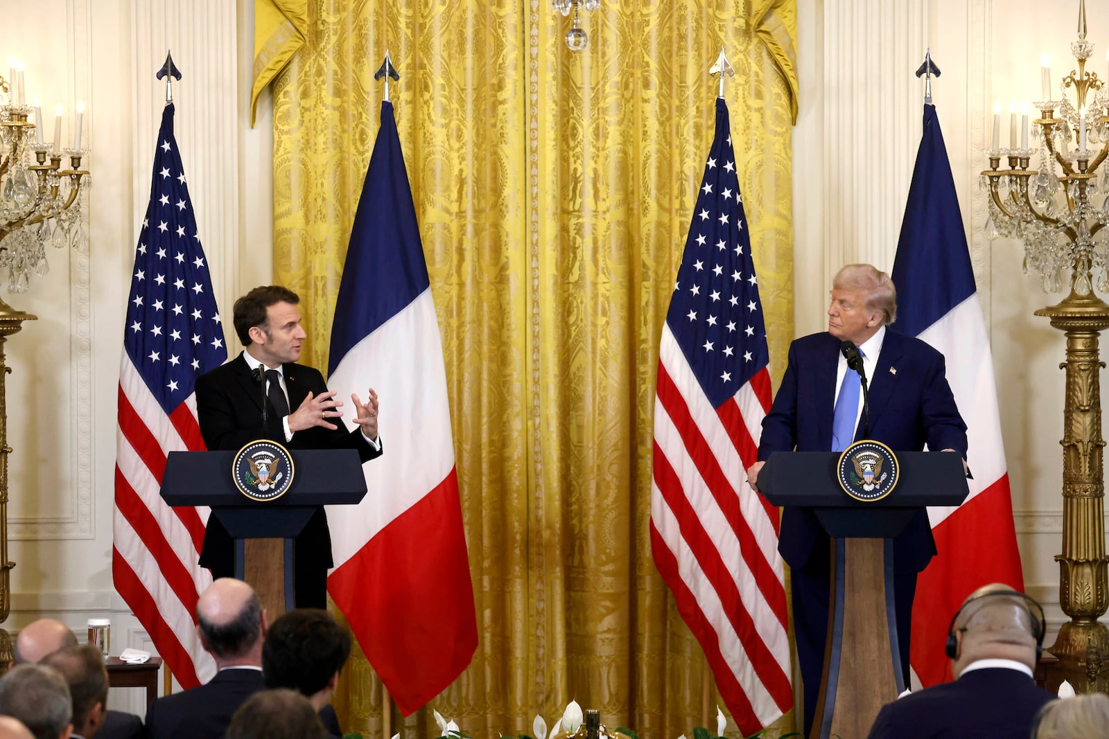 President Donald Trump, right, and France's President Emmanuel Macron attend a joint press conference in the East Room of the White House in Washington, Monday, Feb. 24, 2025. (Ludovic Marin/Pool via AP)