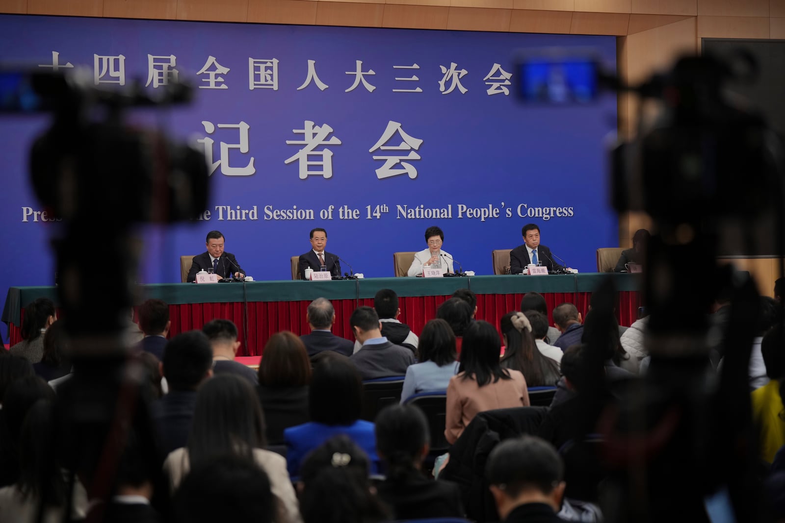 From left to right, Ni Hong, minister of Housing and Urban-Rural Development, Lu Zhiyuan, minister of Civil Affairs, Wang Xiaoping, minister of Human Resources and Social Security and Lei Haichao, minister of the National Health Commission, attend a press conference for the second session on the sideline of the National People's Congress in Beijing, China, Sunday, March 9, 2025. (AP Photo/Vincent Thian)