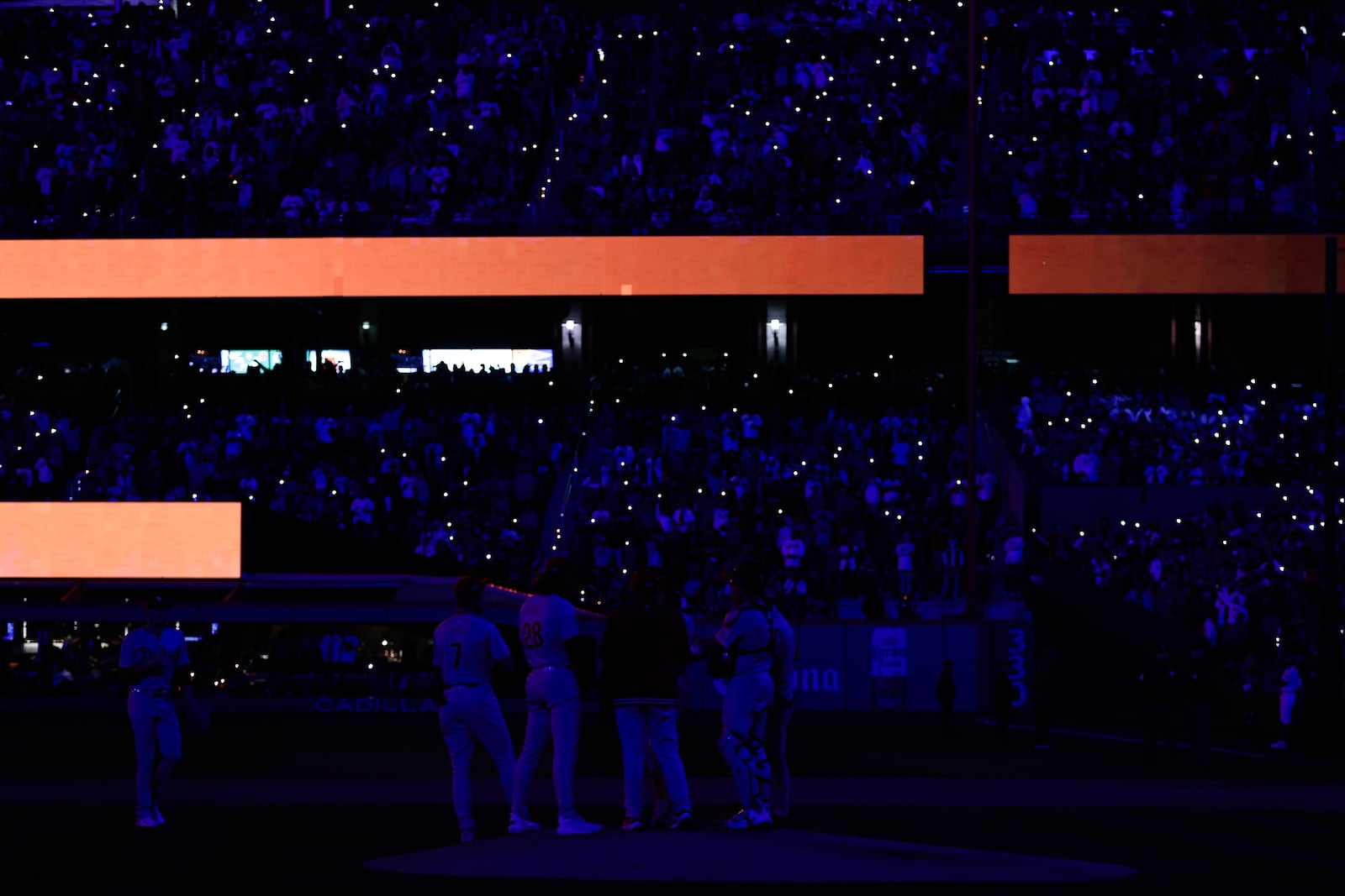 LED and cell phone lights flash through Citi Field during a pitching change by the Philadelphia Phillies during the fifth inning of Game 4 of the National League baseball playoff series against the New York Mets, Wednesday, Oct. 9, 2024, in New York. (AP Photo/Adam Hunger)