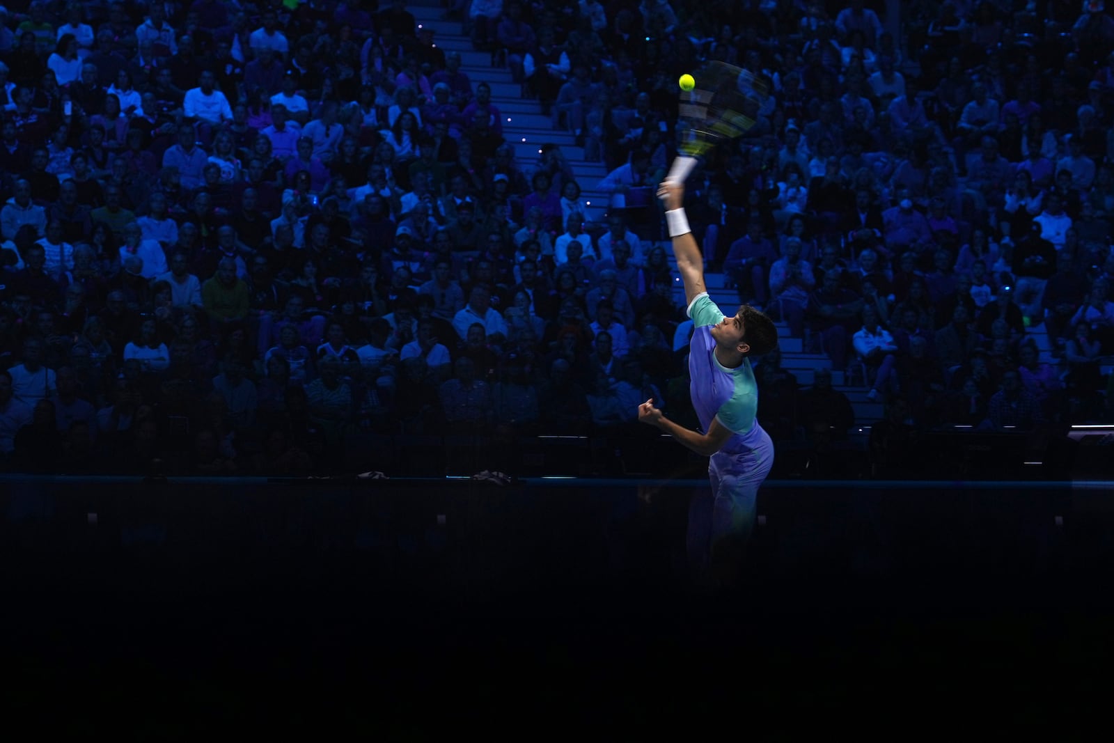 Spain's Carlos Alcaraz returns the ball to Denmark's Casper Ruud during their singles tennis match of the ATP World Tour Finals at the Inalpi Arena, in Turin, Italy, Monday, Nov. 11, 2024. (AP Photo/Antonio Calanni)