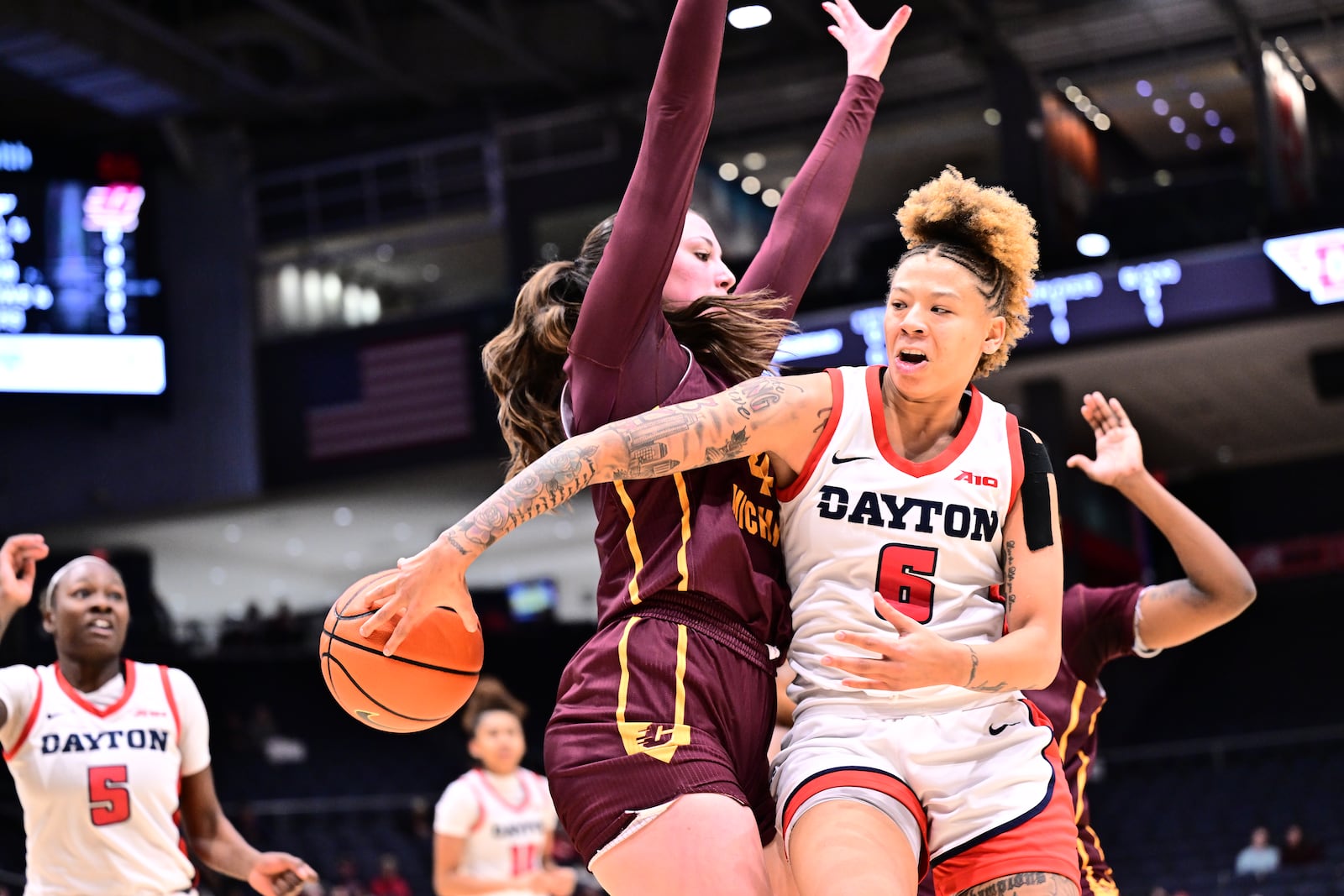 Dayton's Rikki Harris delivers a pass in traffic during Sunday's game vs. Central Michigan at UD Arena. Erik Schelkun/UD Athletics photo