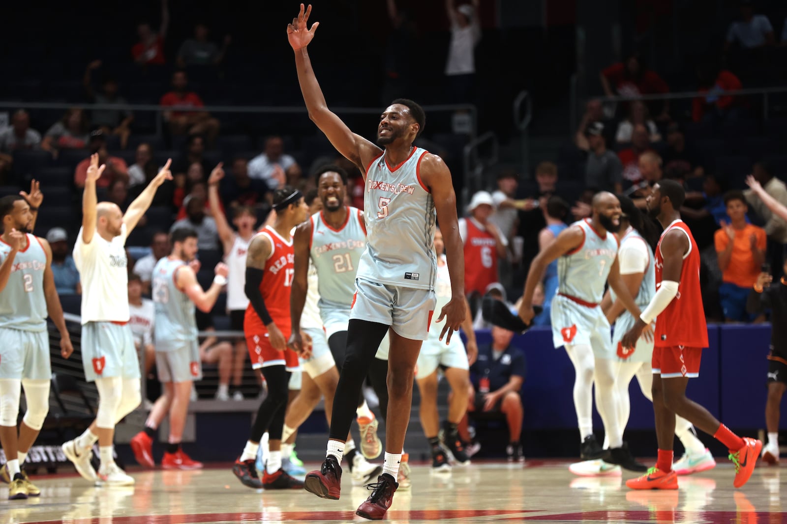 Andre Wesson, of Carmen's Crew, celebrates after making the game-clinching Elam Ending shot against Red Scare in the second round of The Basketball Tournament on Monday, July 22, 2024, at UD Arena. David Jablonski/Staff