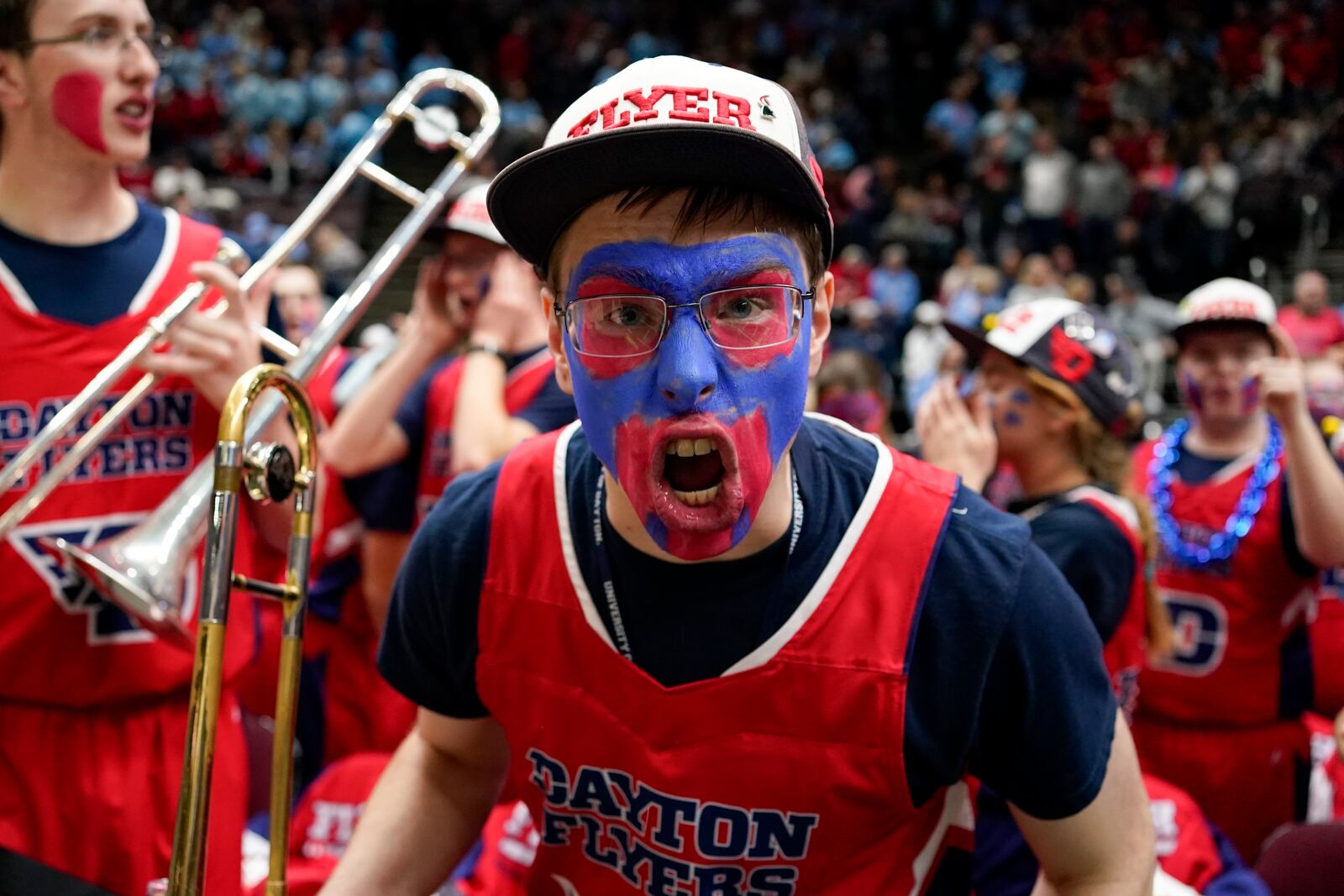 A member of the Dayton band cheers prior to an NCAA college basketball game against Cincinnati, Friday, Dec. 20, 2024, in Cincinnati. (AP Photo/Jeff Dean)