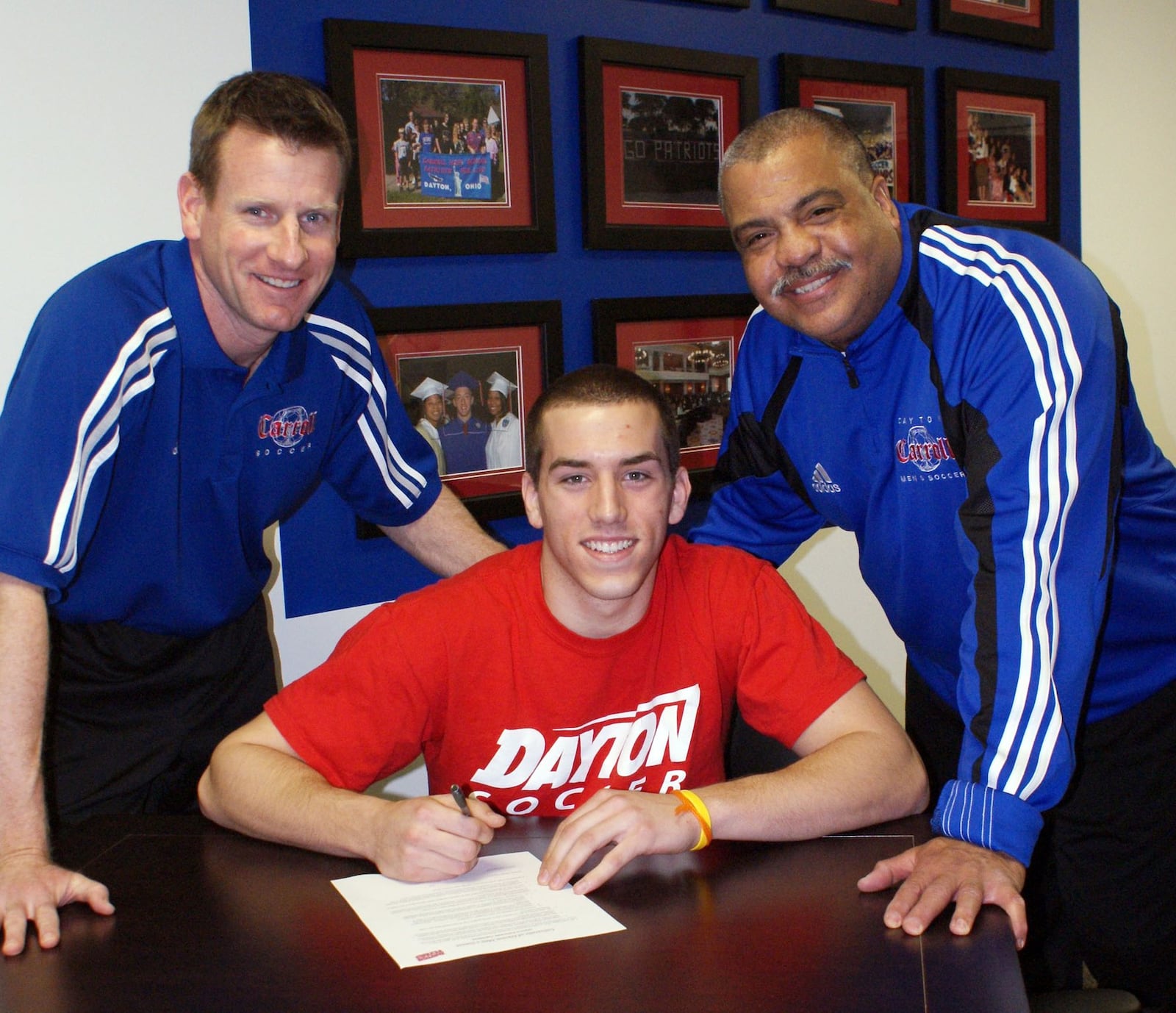 Carroll High School soccer All-American Jon Buschur signed a National Letter of Intent to continue his career at the University of Dayton. Joining Jon on Signing Day were Carroll coach Scott Molfenter (left) and assistant coach Daryl Jones. Buschur helped the Patriots finish 17-2-1 last season. CONTRIBUTED