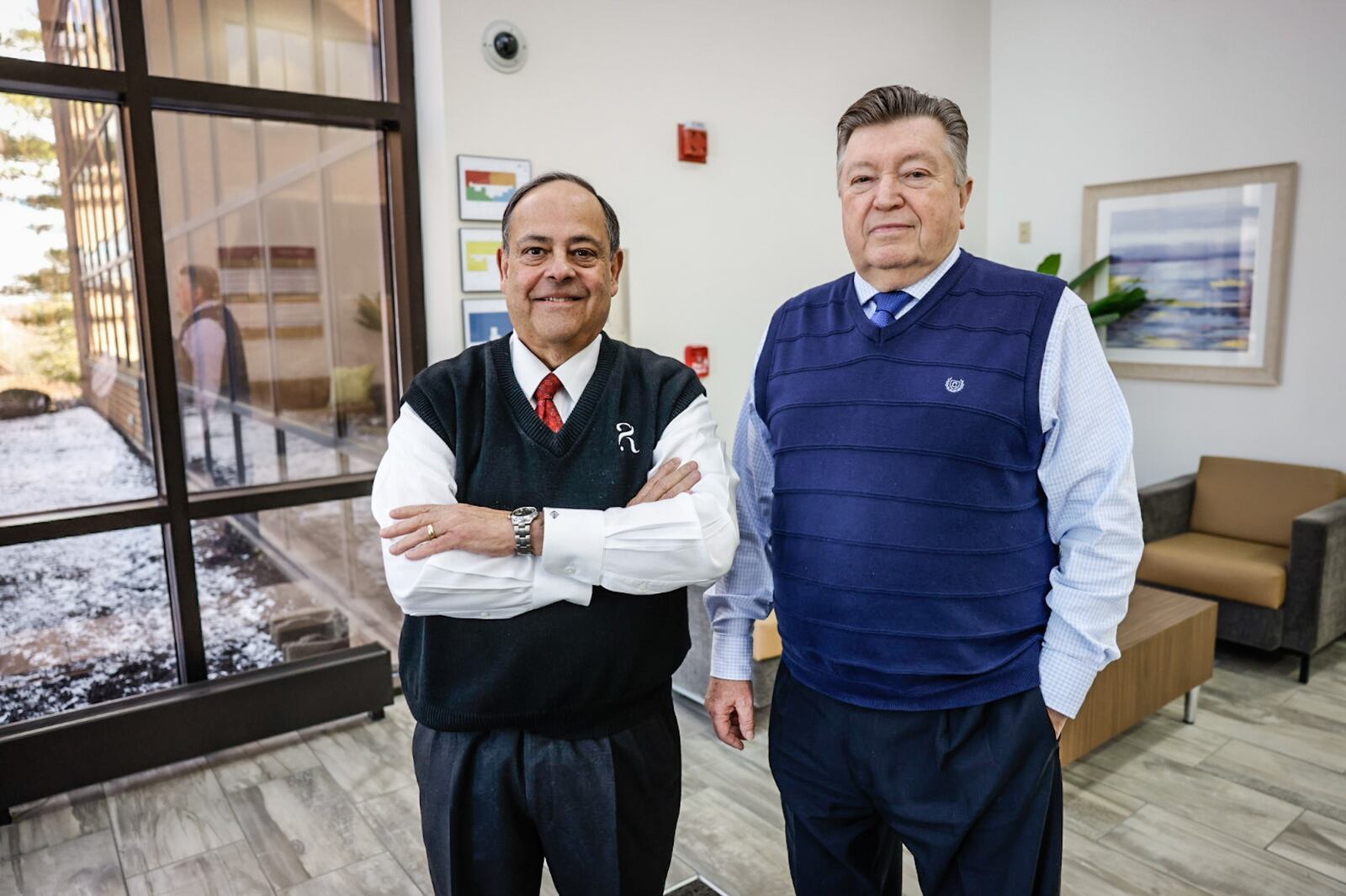 Financial adviser, Rafi Rodriguez, left and long-term care adviser, Randy Gallas believe people should get regular retirement checkups with a financial adviser. JIM NOELKER/STAFF