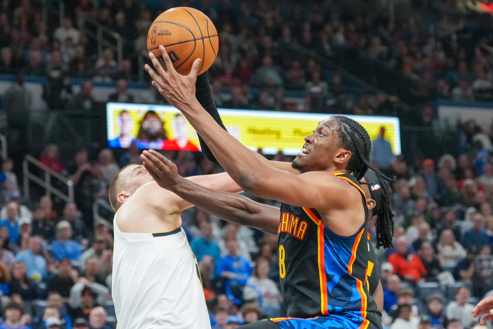 Oklahoma City Thunder forward Jalen Williams, right, shoots over Denver Nuggets center Nikola Jokic, left, during the second half of an NBA basketball game, Sunday, March 9, 2025, in Oklahoma City. (AP Photo/Kyle Phillips)