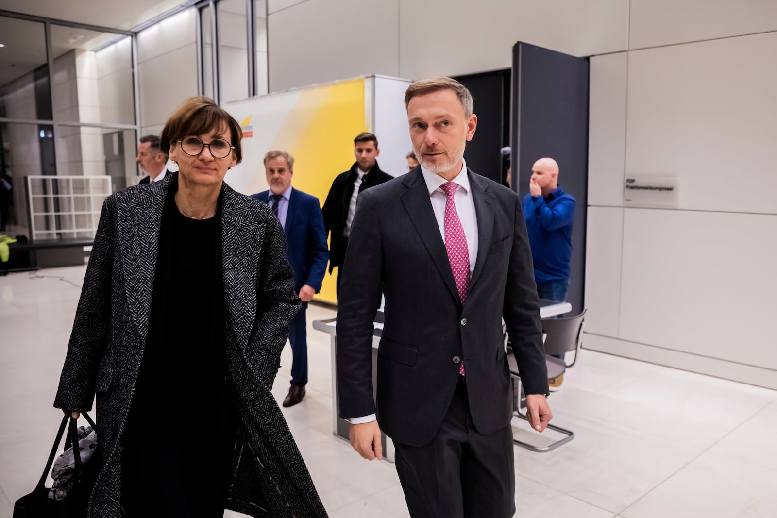 Federal Minister of Finance Christian Lindner, right, leaves the parliamentary group meeting room with Minister of Education and Research Bettina Stark-Watzinger, left, after a parliamentary group meeting following his dismissal by the Federal Chancellor Olaf Scholz, in Berlin, Wednesday, Nov. 6, 2024. (Christoph Soeder/dpa via AP)