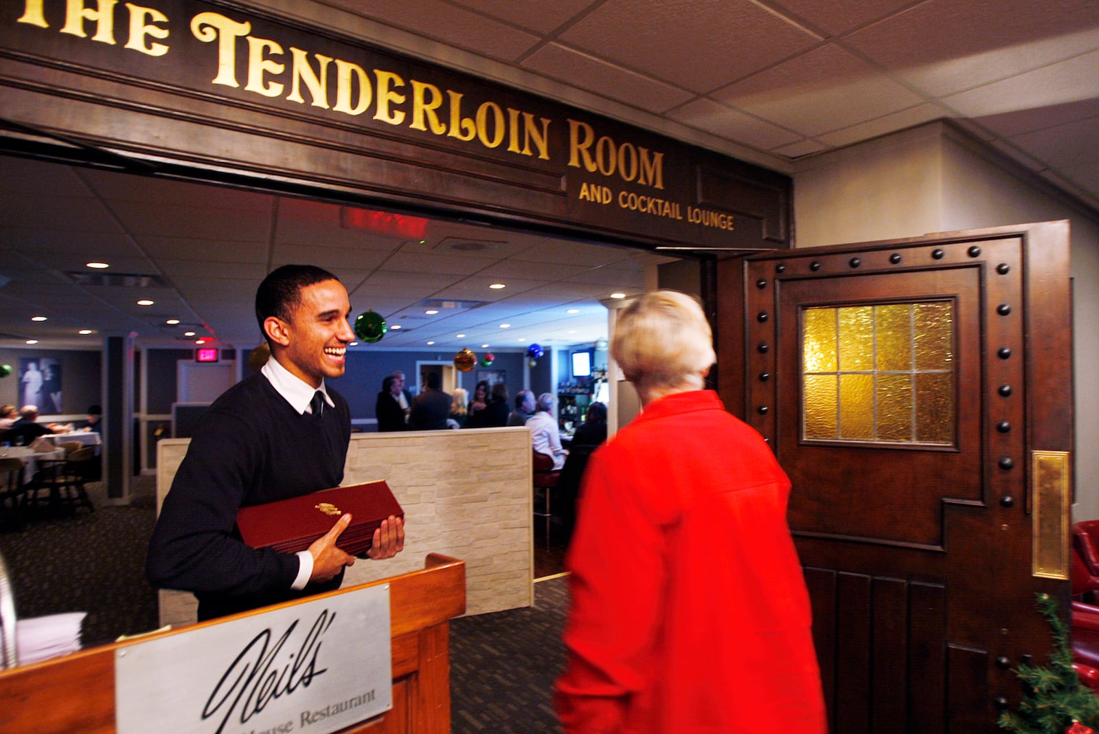 Maitre d' Matthew Cotton greets guest at Neil's Heritage House in Kettering.