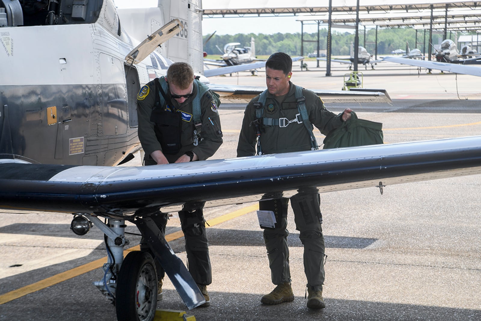 Maj. Owen John Williams goes over the preflight checklist with pilot Capt. Michael Nault prior to his orientation flight in the T-6 Texan at Columbus Air Force Base, Miss., on April 14. U.S. AIR FORCE PHOTO/KEITH WRIGHT