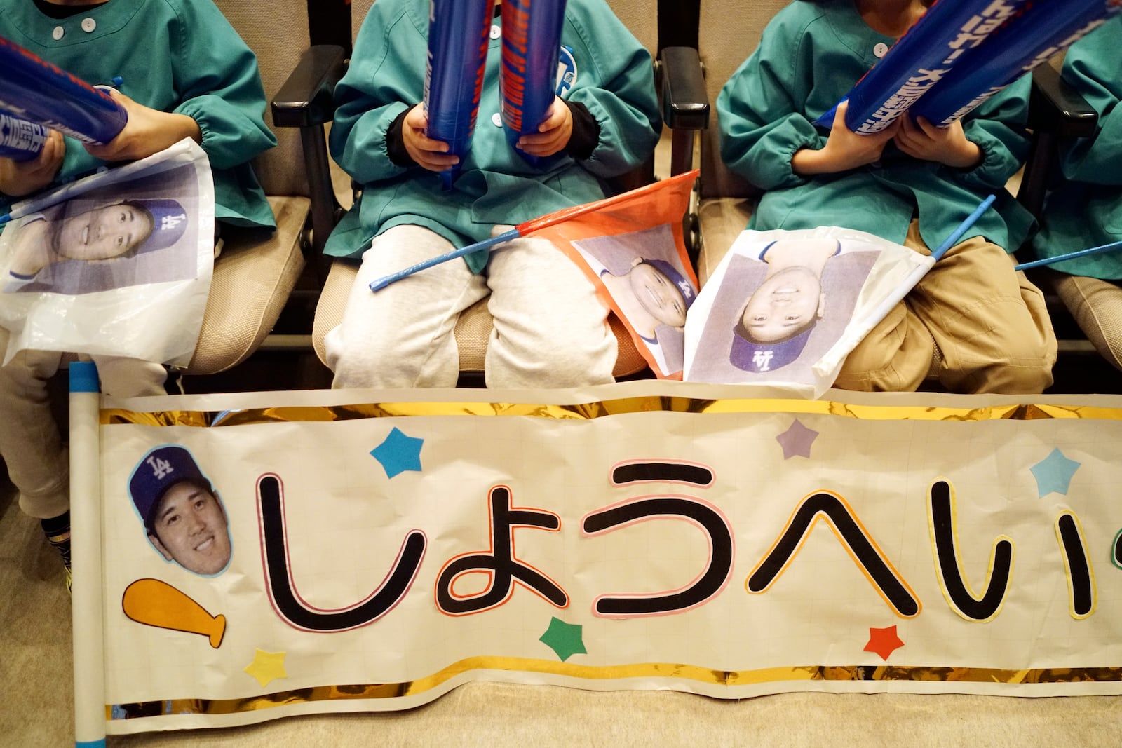 Pupils from Tokiwa Kindergarten where Shohei Ohtani graduated watch on a live stream of Game 3 of the baseball World Series between Los Angeles Dodgers and New York Yankees during a public viewing event in Oshu, northeast of Japan, the hometown of Shohei Ohtani of the Los Angeles Dodgers Tuesday, Oct. 29, 2024. The banner reads "Shohei." (AP Photo/Eugene Hoshiko)