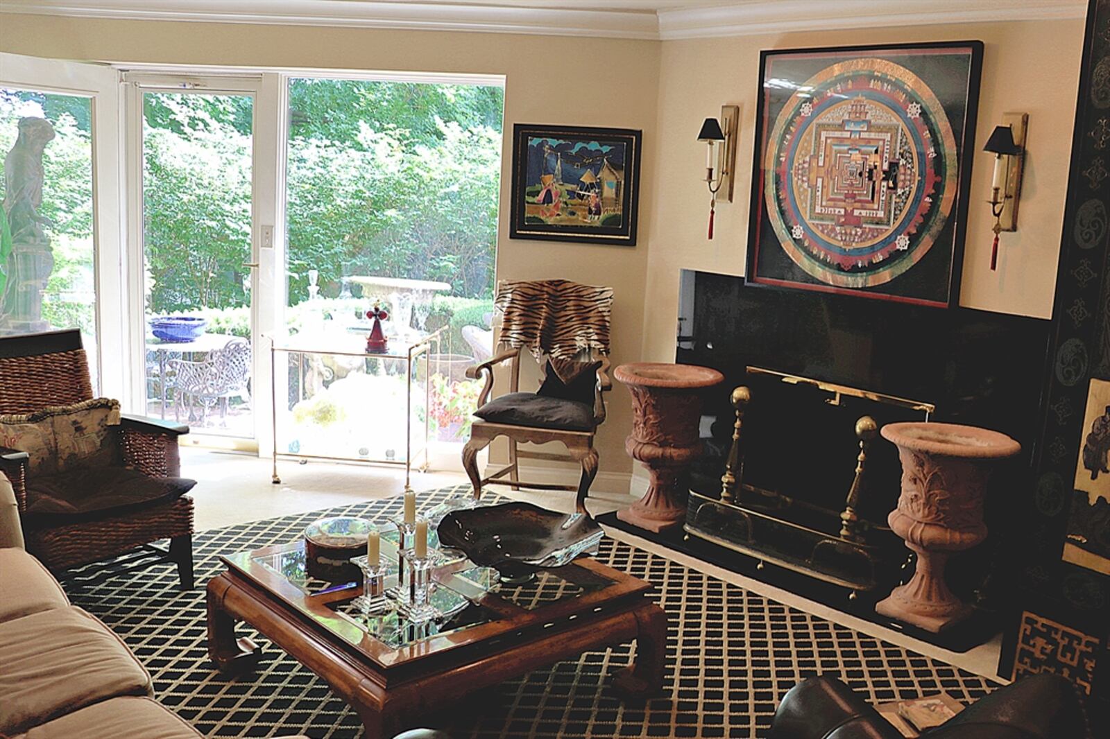 Floor-to-ceiling windows and glass patio doors fill the great room with natural light and allow views of the courtyard patio. The patio doors open to the paver-brick patio.