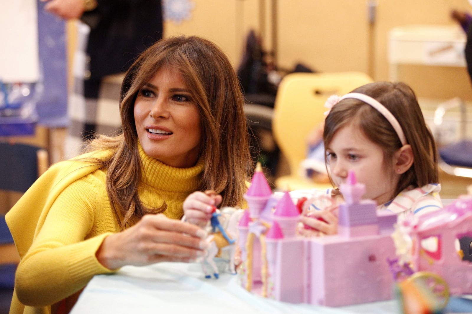 First Lady Melania Trump plyas with Maya Baughman, 5, during a visit to Cincinnati Children’s Hospital Monday. LISA POWELL / STAFF