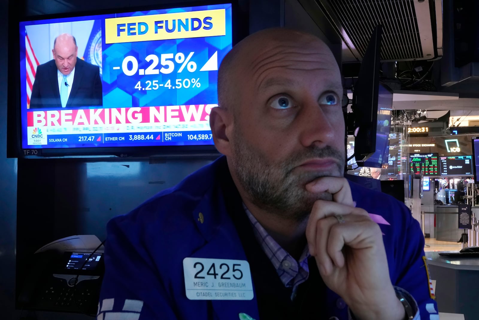 Specialist Meric Greenbaum works on the floor of the New York Stock Exchange as the rate decision of the Federal Reserve is announced, Wednesday, Dec. 18, 2024. (AP Photo/Richard Drew)