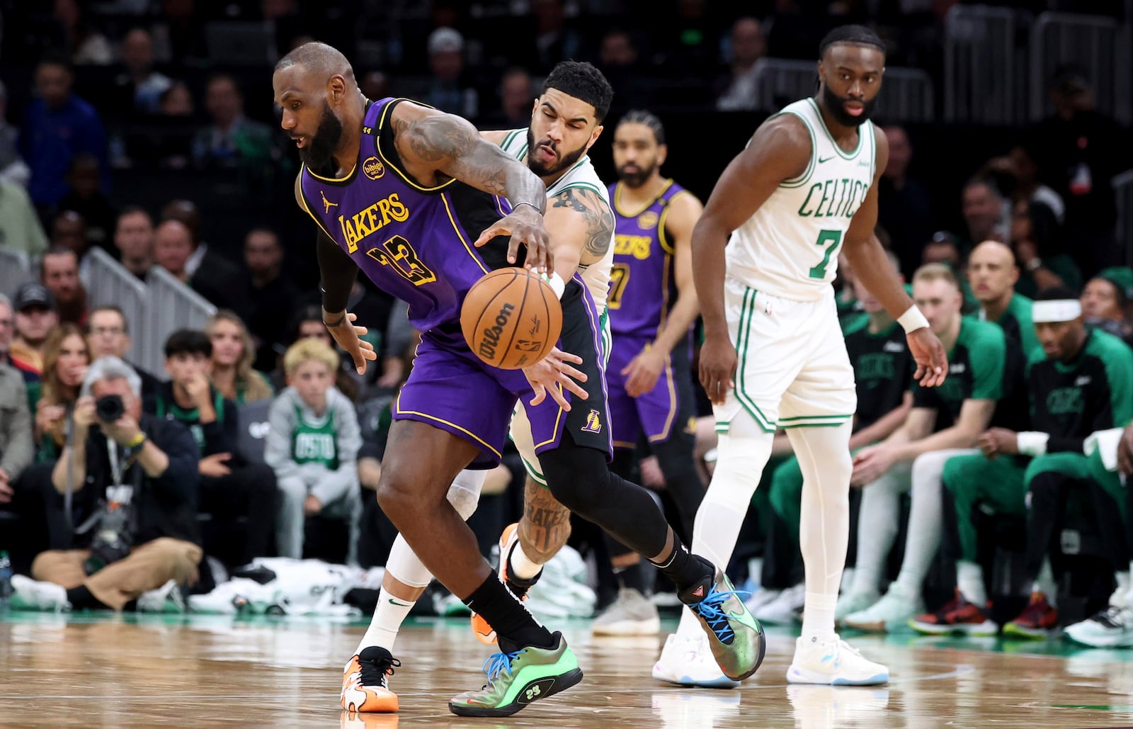 Boston Celtics forward Jayson Tatum knocks the ball loose from Los Angeles Lakers forward LeBron James (23) during the second half of an NBA basketball game, Saturday, March 8, 2025, in Boston. (AP Photo/Mark Stockwell)