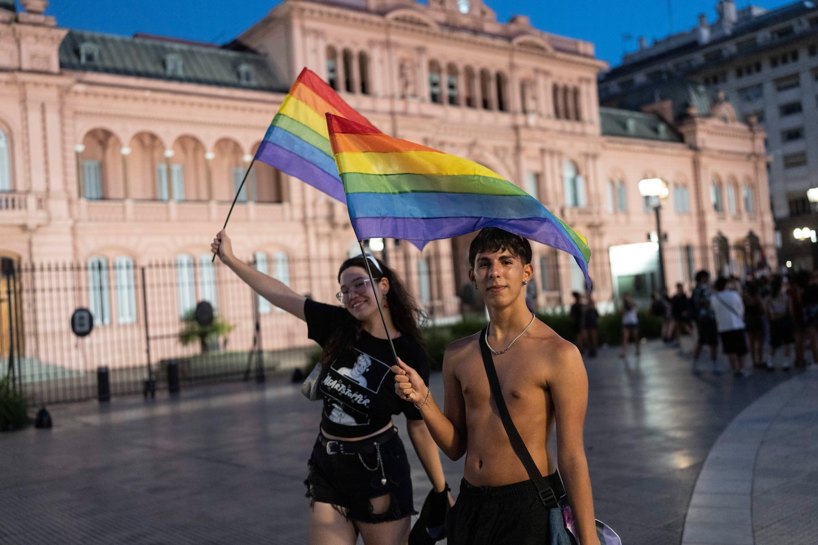 People holding rainbow-colored flags gather in Buenos Aires, Argentina, Saturday, Feb. 1, 2025, to protest President Javier Milei’s speech at the World Economic Forum in Davos, during which he criticized “sick wokeism,” social welfare, feminism, identity politics and the fight against climate change. (AP Photo/Rodrigo Abd)