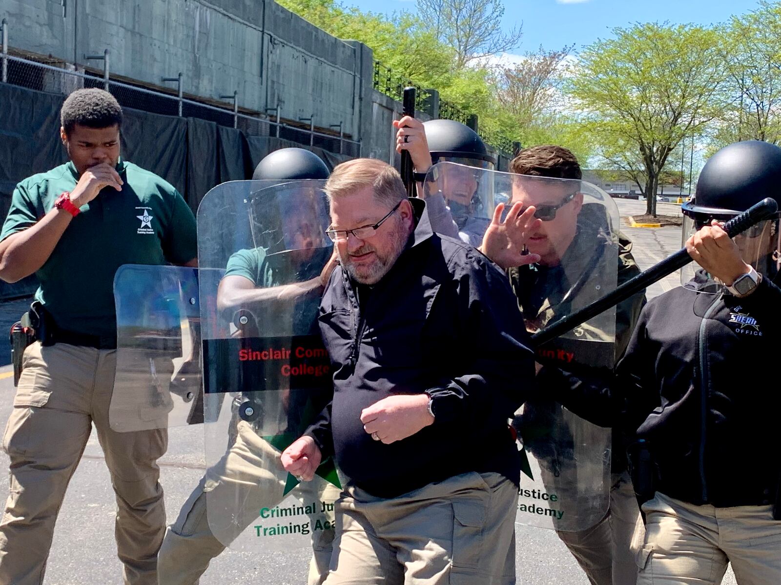 Sinclair Police Academy Commander Jeff Thomas attempts to break through a line of cadets during civil disorder training. LONDON BISHOP/STAFF