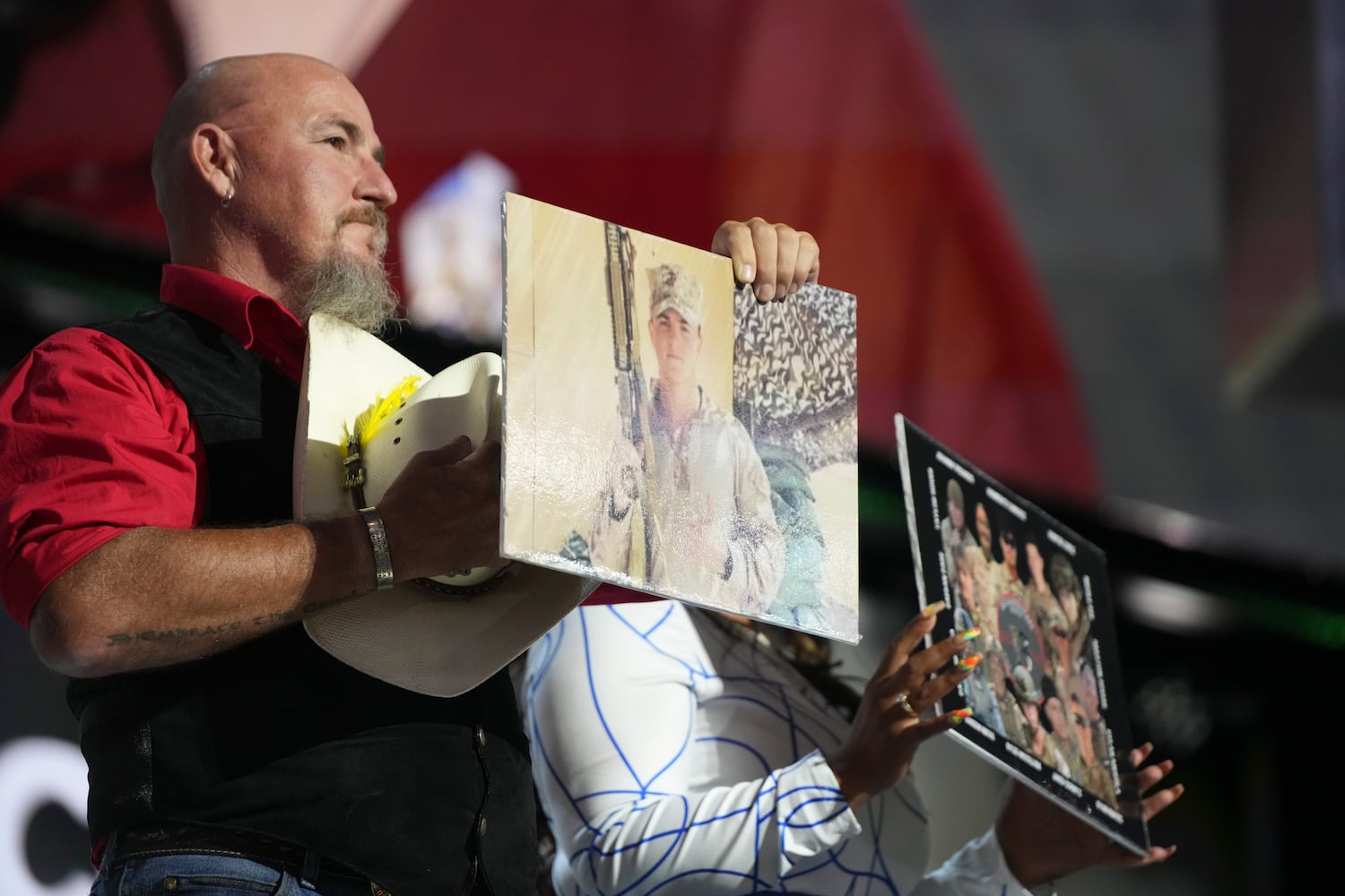 
                        Relatives of some of the 13 U.S. service members killed in the August 2021 bombing at the Kabul airport’s Abbey Gate hold photos of their family members on the third night of the Republican National Convention at the Fiserv Forum in Milwaukee, on Wednesday, July 17, 2024. (Todd Heisler/The New York Times)
                      