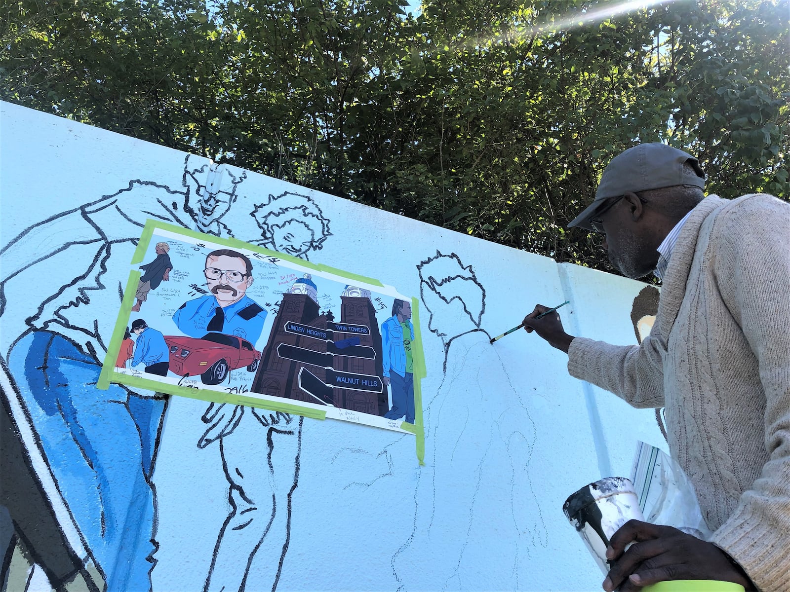 Artist Morris Howard works on the new Steve Whalen memorial mural in southeast Dayton on Friday. CORNELIUS FROLIK / STAFF