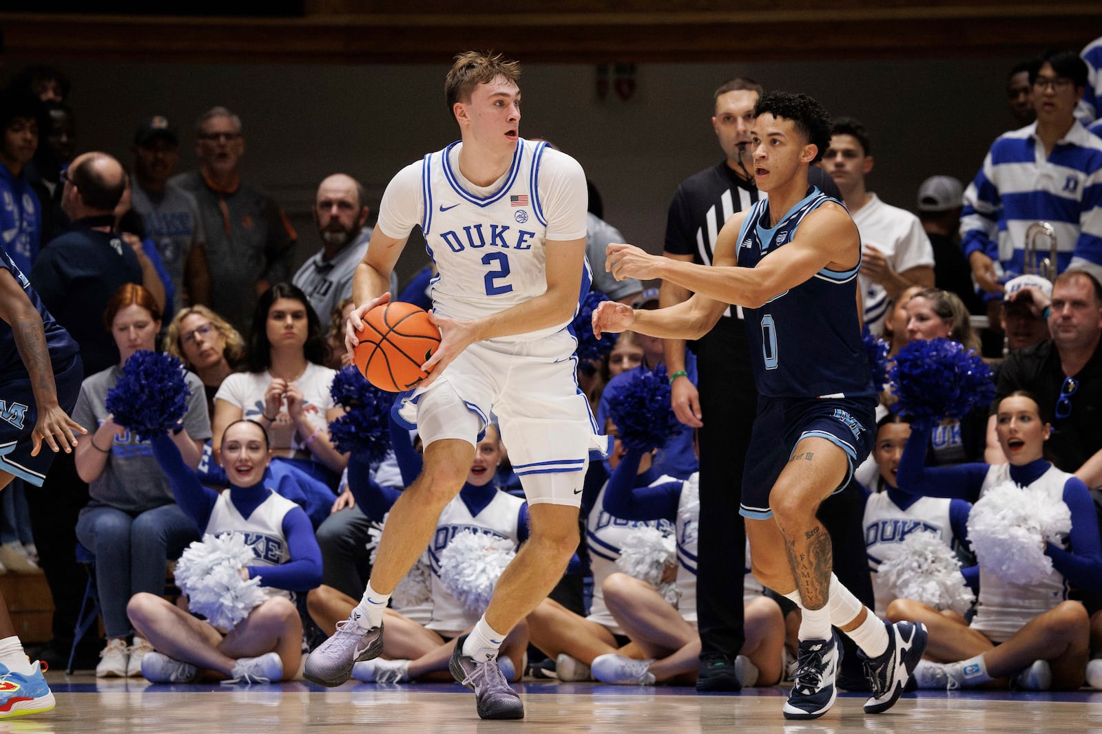 Duke's Cooper Flagg (2) handles the ball as Maine's Logan Carey (0) defends during the first half of an NCAA college basketball game in Durham, N.C., Monday, Nov. 4, 2024. (AP Photo/Ben McKeown)