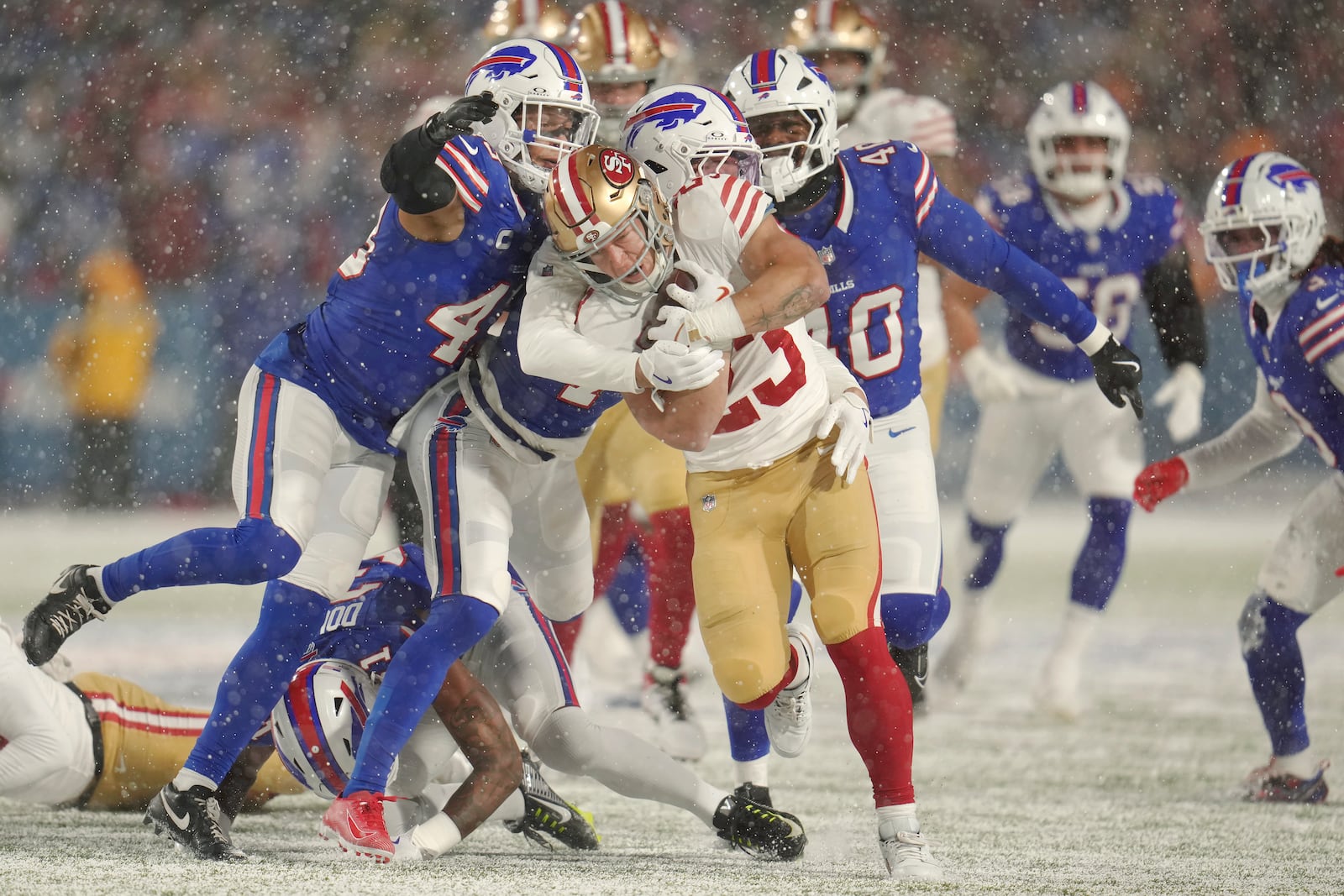 San Francisco 49ers running back Christian McCaffrey, middle, runs against the Buffalo Bills during the first half of an NFL football game in Orchard Park, N.Y., Sunday, Dec. 1, 2024. (AP Photo/Gene J. Puskar)