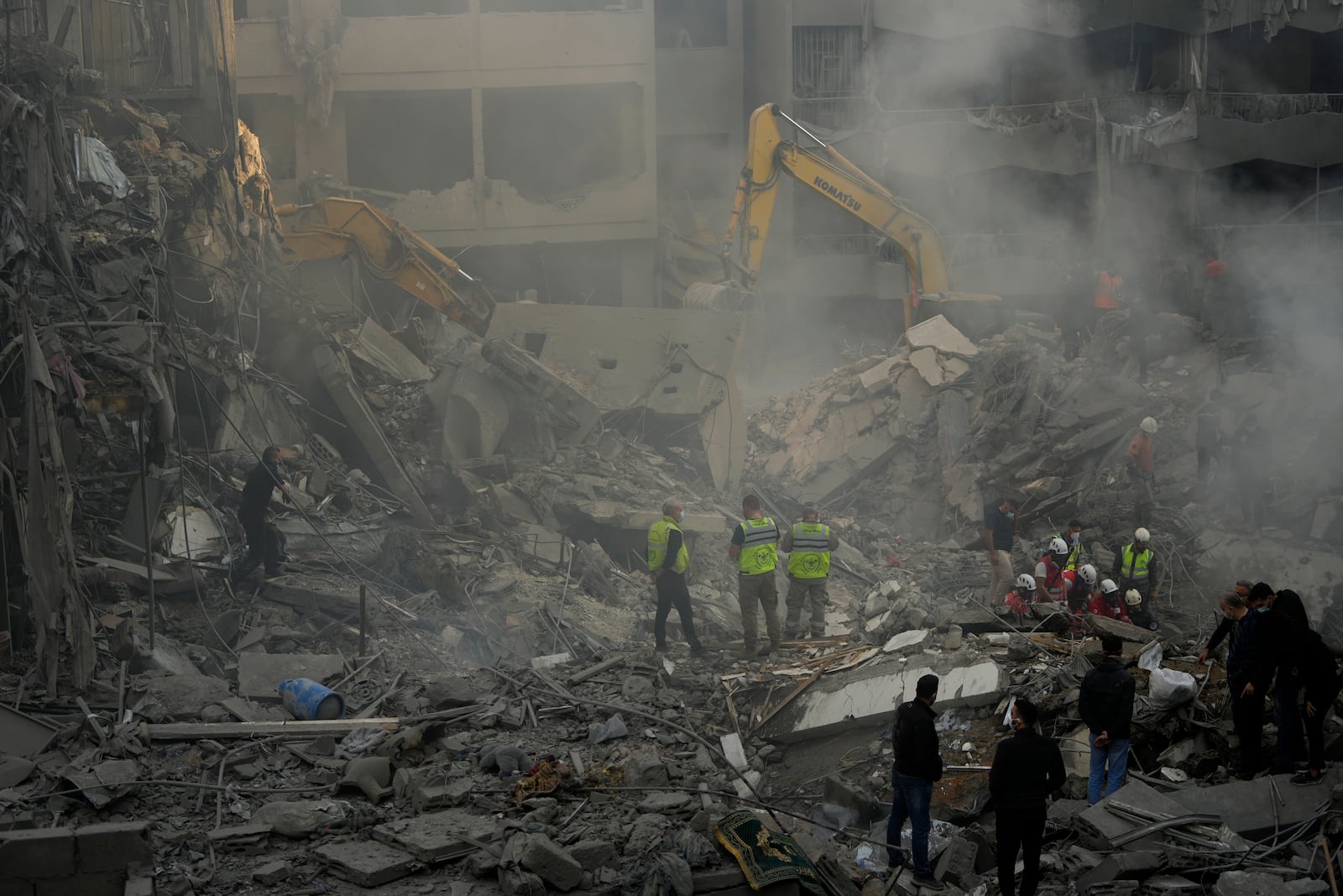 Rescue workers and people search for victims at the site of an Israeli airstrike that hit central Beirut, Lebanon, Saturday, Nov. 23, 2024. (AP Photo/Hassan Ammar)