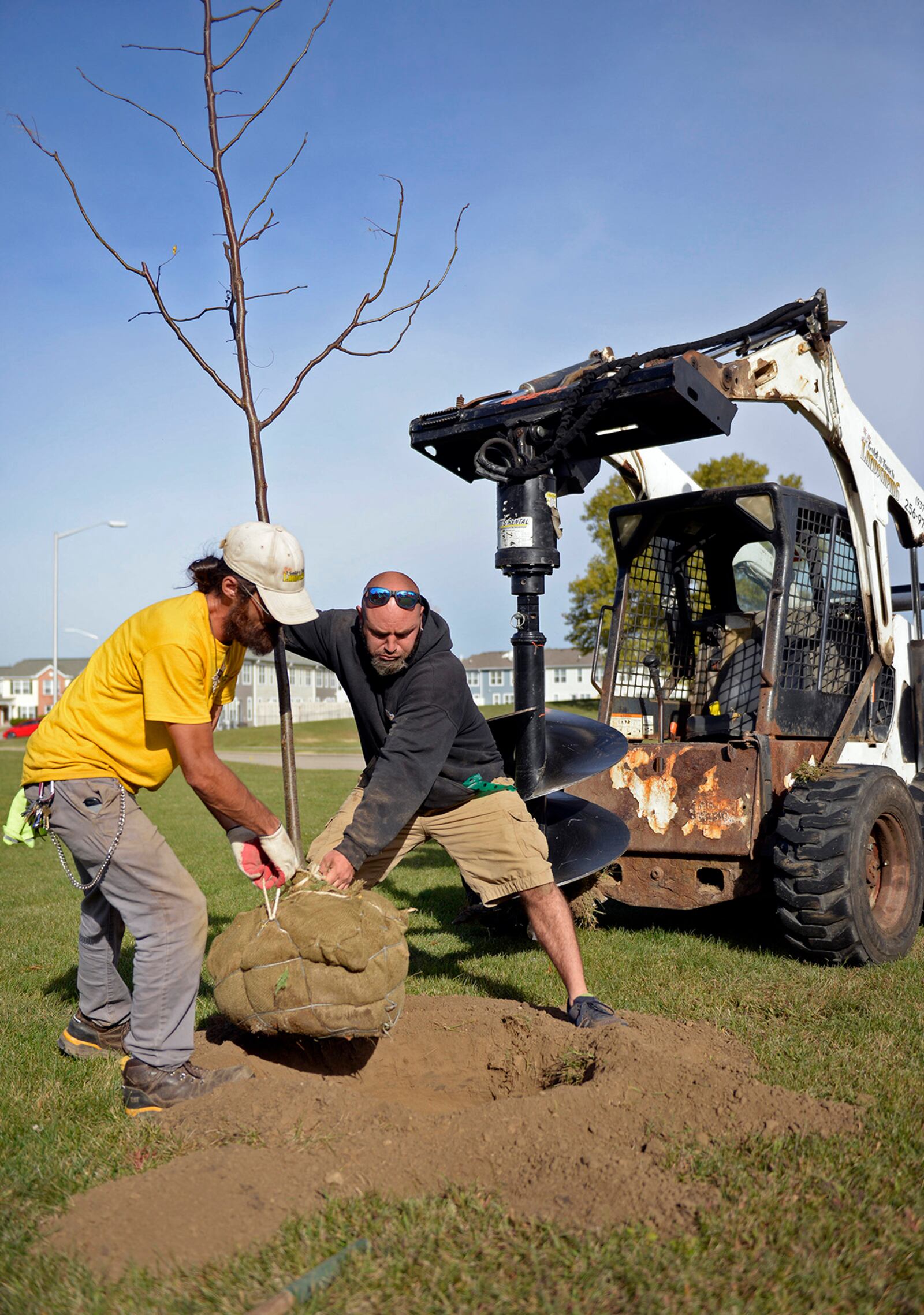 Landscape workers Brandon Burke (left) and Chris Ryan plant a honey locust tree on the Properties at Wright Field, Wright-Patterson Air Force Base, Oct. 14. Through a grant from the Arbor Day Foundation, 83 trees of four different varieties were purchased from local nurseries to replace trees lost from tornadoes in 2019. U.S. AIR FORCE PHOTO/TY GREENLEES