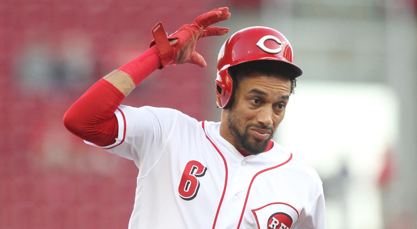 The Reds Billy Hamilton tries to hold onto his helmet as he runs to third base against the Cardinals on Thursday, April 12, 2018, at Great American Ball Park in Cincinnati. David Jablonski/Staff