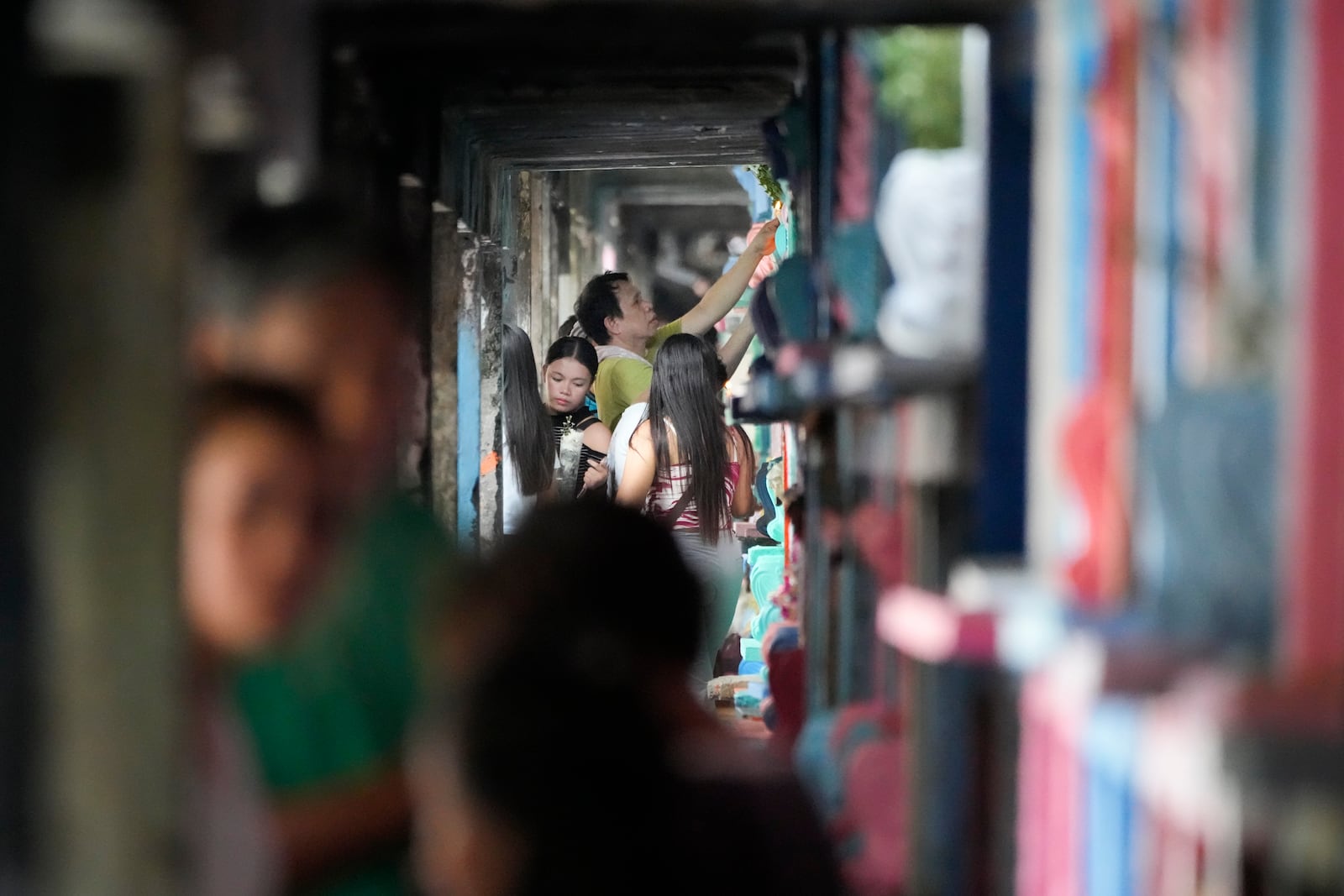 People visit apartment-type tombs of their departed loved ones in at a crowded Manila's North Cemetery, Philippines as the nation observes All Saints Day on Friday, Nov. 1, 2024. (AP Photo/Aaron Favila)