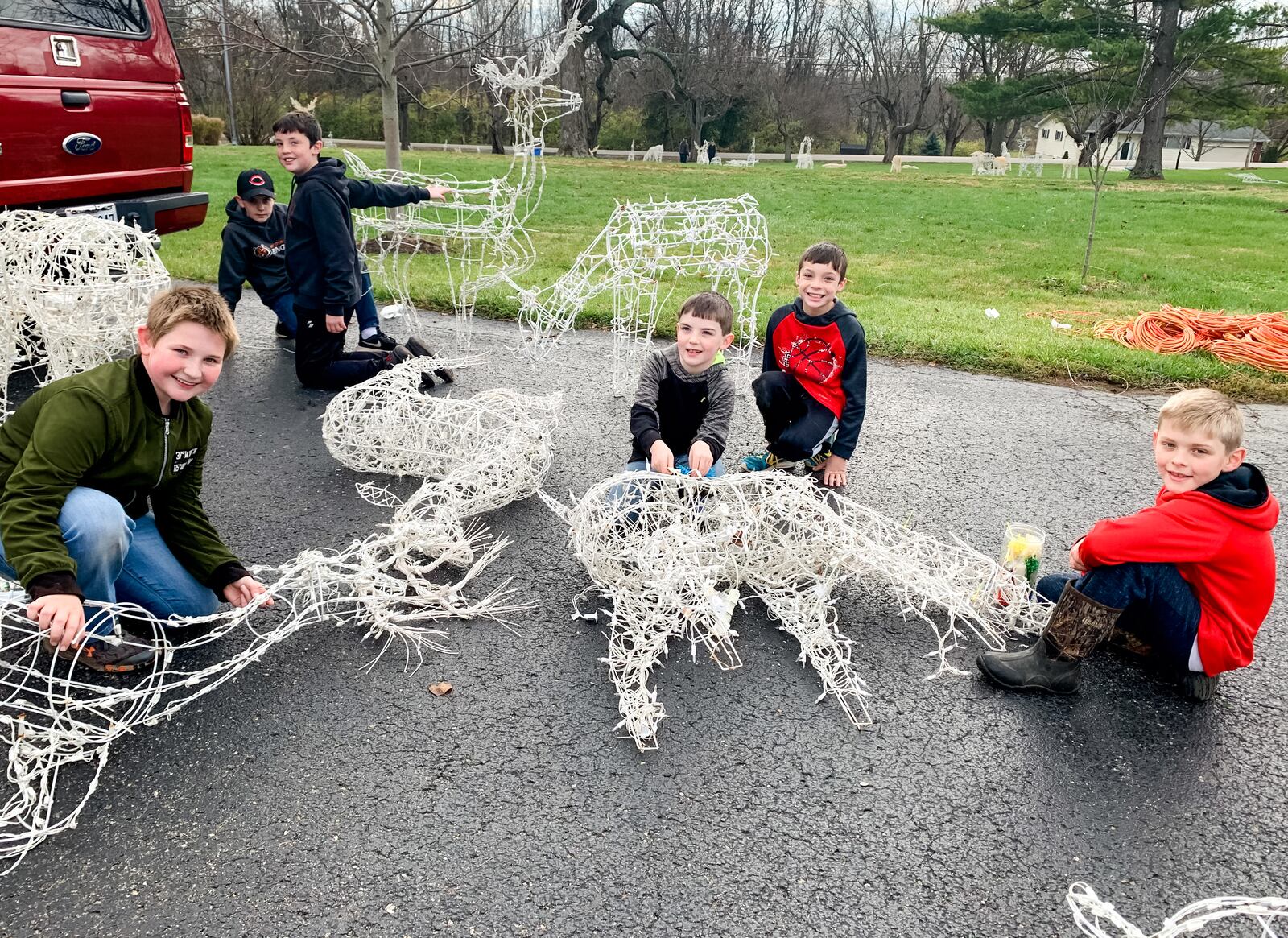 The Derr family had friends over to set up the display this year, and their sons and friends examined all the reindeer to make sure the lights were working and all parts were attached. CONTRIBUTED