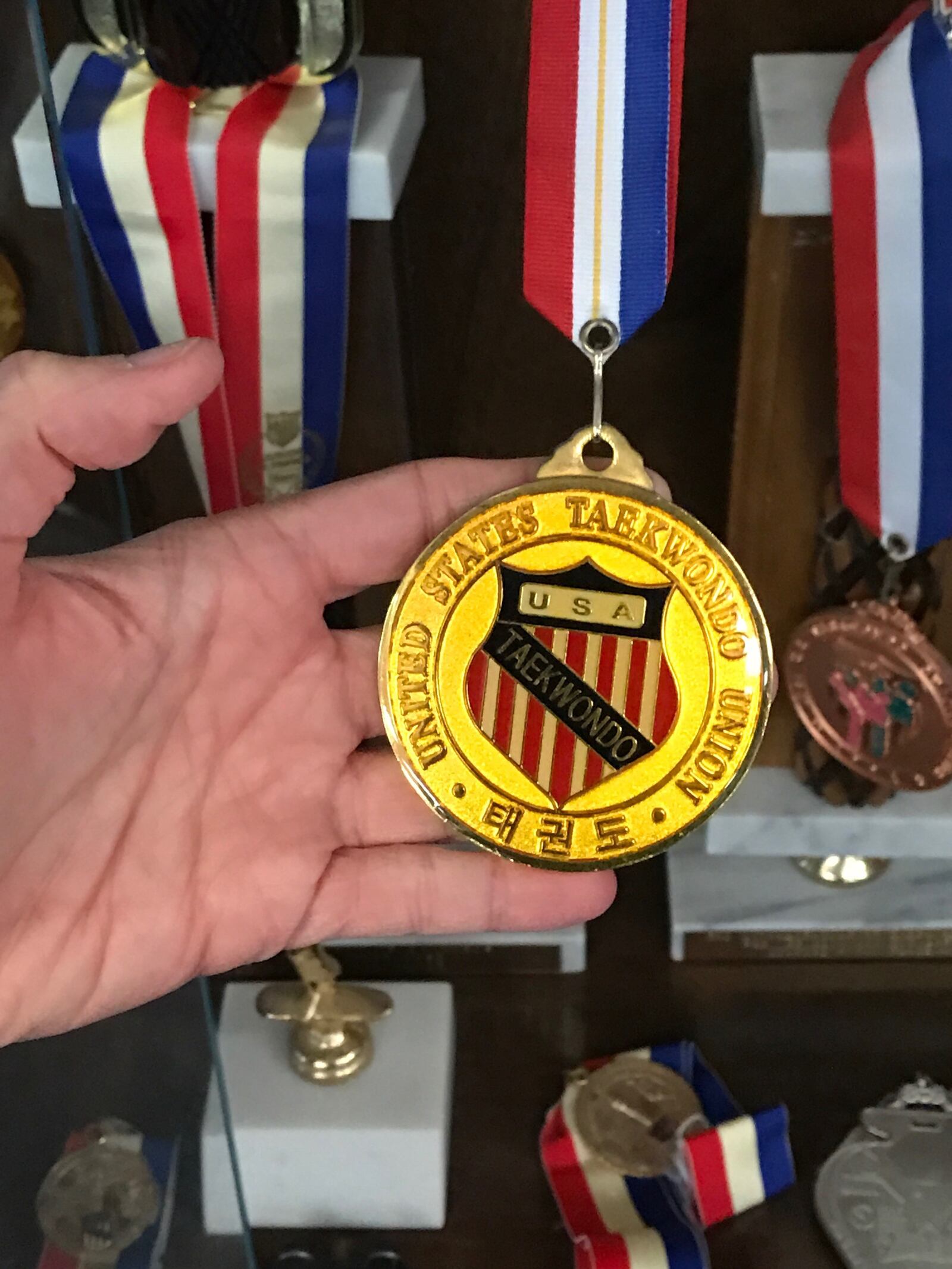 Christina Bayley holds the medal she won as the heavyweight champion at the U.S. Olympic Trials in 1996. That put her on the U.S, team headed to the 1996 Olympic Games in Atlanta, but the IOC then dropped taekwondo as a demonstration sport in 1996. By the next games – 2000 in Sydney, Australia – they were a full medal sport. Tom Archdeacon/STAFF