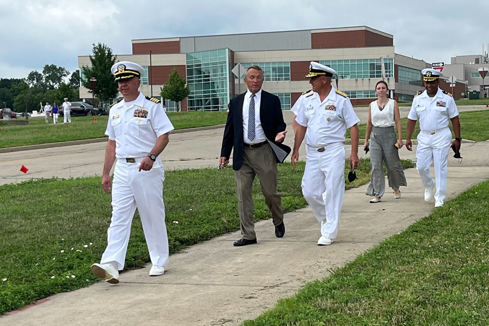 Retired Brig. Gen. Scott Wuesthoff and Rear Adm. John Spencer, Submarine Group 10 commander, (center) are led on a tour of Naval Medical Research Unit-Dayton's facilities by Capt. Walter Dalitsch III (front) on July 26 at Wright-Patterson Air Force Base. Wuesthoff and Spencer visited the command as part of a ceremony re-dedicating a memorial plaque for World War II-era research Cmdr. Eric Liljencrantz, a leader in aeromedical research and Wueshoff's grandfather. NAVAL MEDICAL RESEARCH UNIT-DAYTON PHOTO/ZACHARY WILSON