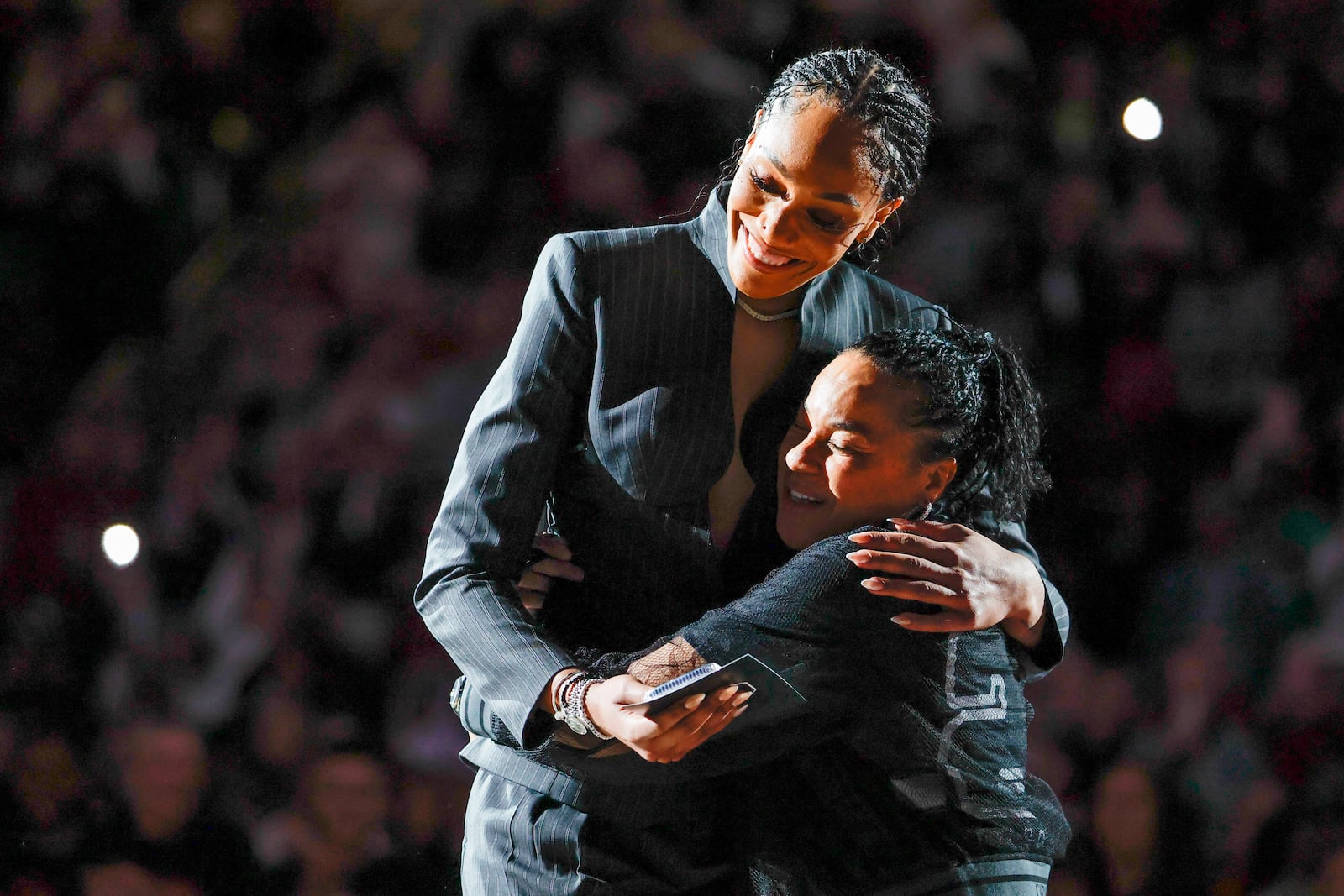 A'ja Wilson, left, and South Carolina head coach Dawn Staley embrace during a ceremony for Wilson's number retirement before an NCAA college basketball game between South Carolina and Auburn in Columbia, S.C., Sunday, Feb. 2, 2025. (AP Photo/Nell Redmond)