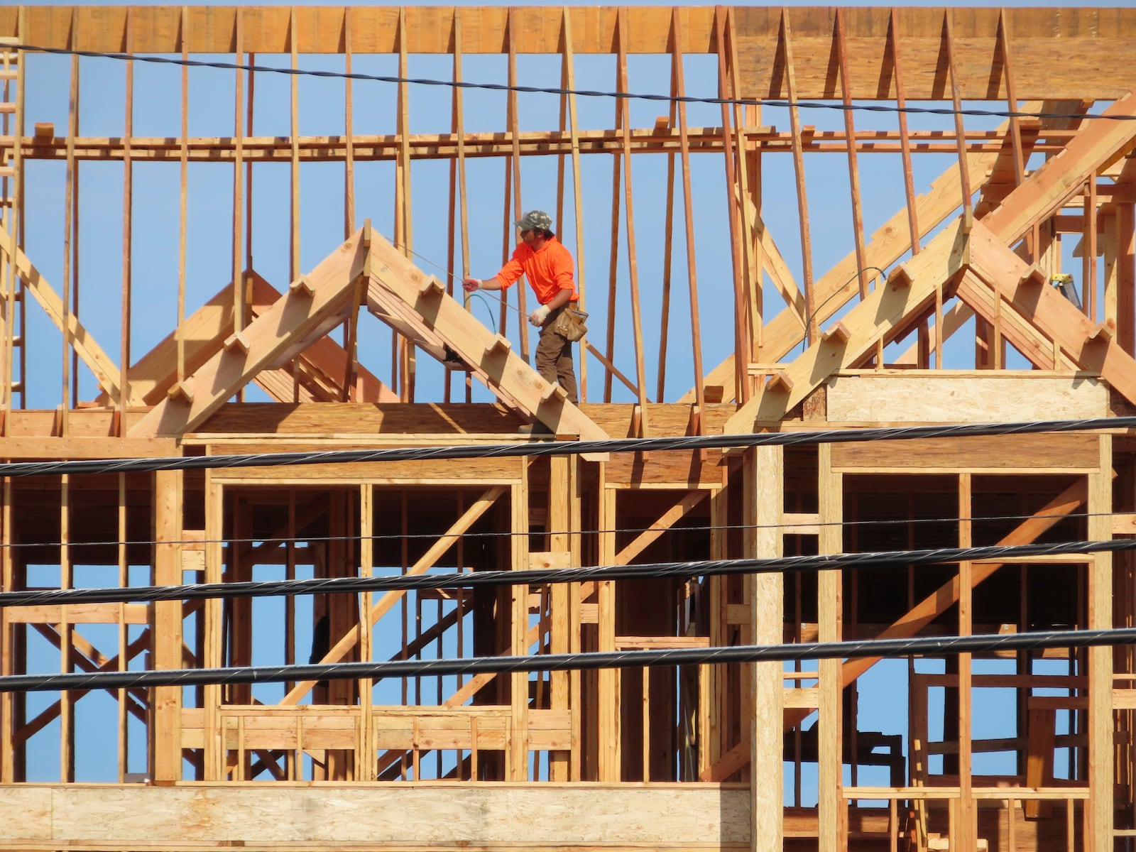 FILE - A construction worker examines part of a building under construction in Brick, N.J. on July 10, 2023. (AP Photo/Wayne Parry, File)