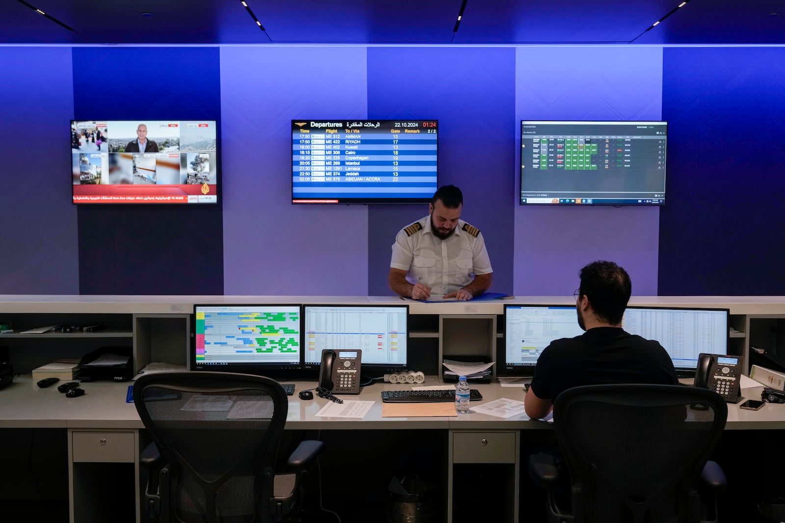 Middle East Airlines employees work in the operations room at the MEA offices in Beirut, Tuesday, Oct. 22, 2024. (AP Photo/Bilal Hussein)