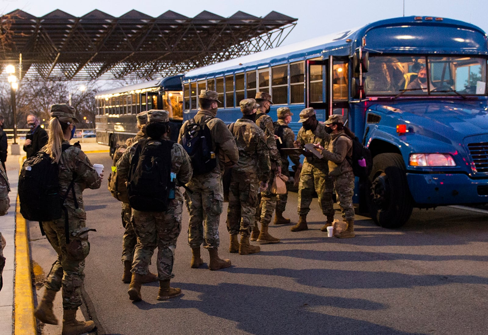 Airmen from the 88th Medical Group board a bus outside Wright-Patterson Medical Center on March 19 as they deploy to Detroit in support of the Federal Emergency Management Agency’s COVID response. The Airmen will set up a COVID-19 vaccination site, where they could vaccinate as many as 6,000 people. U.S. AIR FORCE PHOTO/WESLEY FARNSWORTH