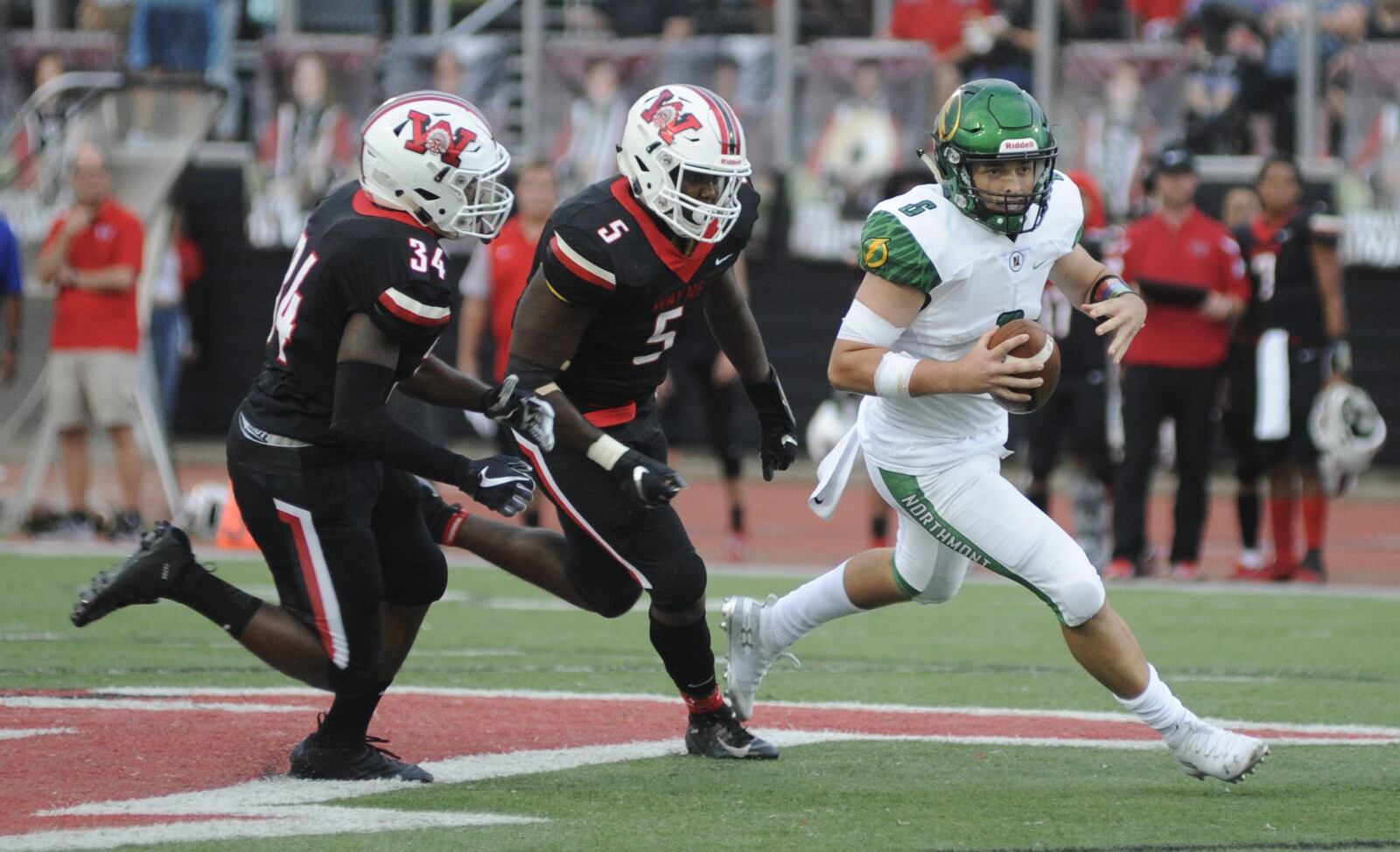 Wayne’s Alijah Fleming (34) and Boogie Walker (5) pursue Northmont QB Miles Johnson. Wayne defeated visiting Northmont 49-20 in a Week 5 high school football game on Friday, Sept. 21, 2018. MARC PENDLETON / STAFF