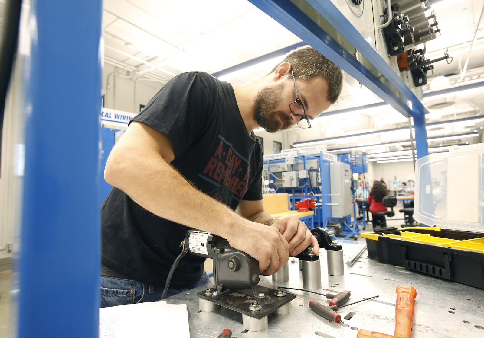 Zac Cox, 29, is completing course work in Sinclair’s Manufacturing Solutions program to improve his skills as a maintenance technician for his employer F&P America Manufacturing in Troy. TY GREENLEES / STAFF