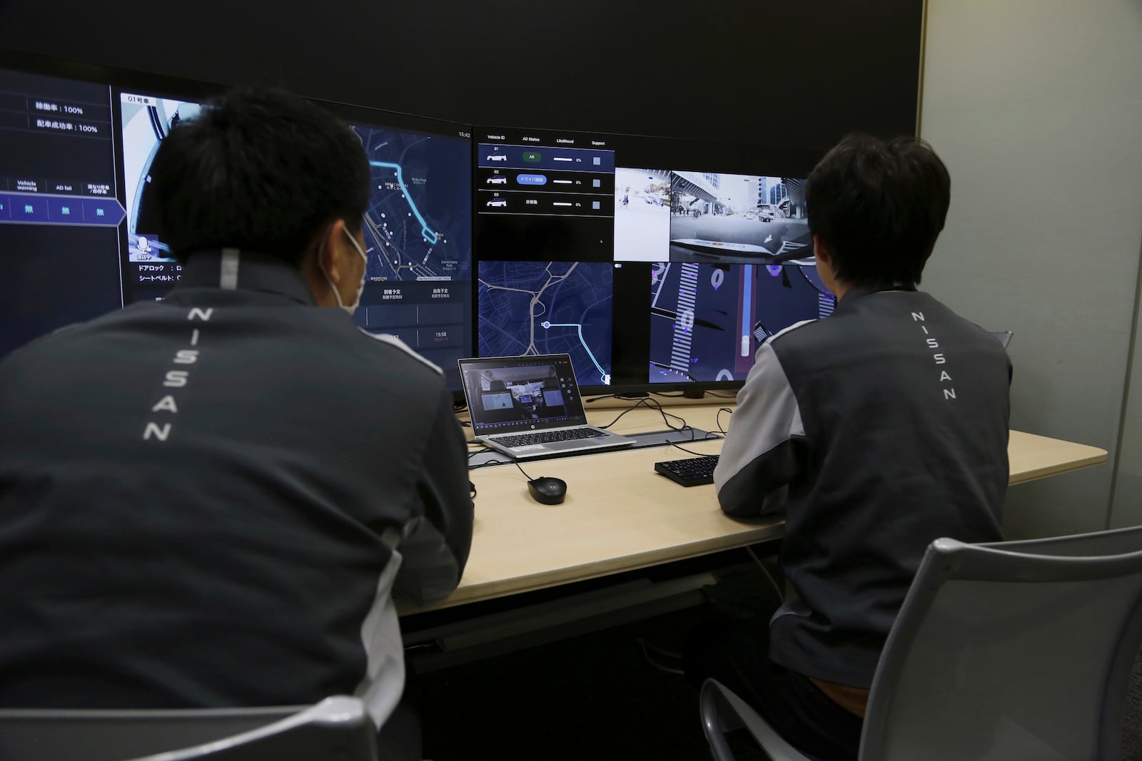 Nissan officials remotely monitor on screens the path and surroundings of the self-driving vehicle being tested on regular roads, so they can step in if problems happen, at Nissan headquarters in Yokohama, near Tokyo on March 6, 2025. (AP Photo/Yuri Kageyama)